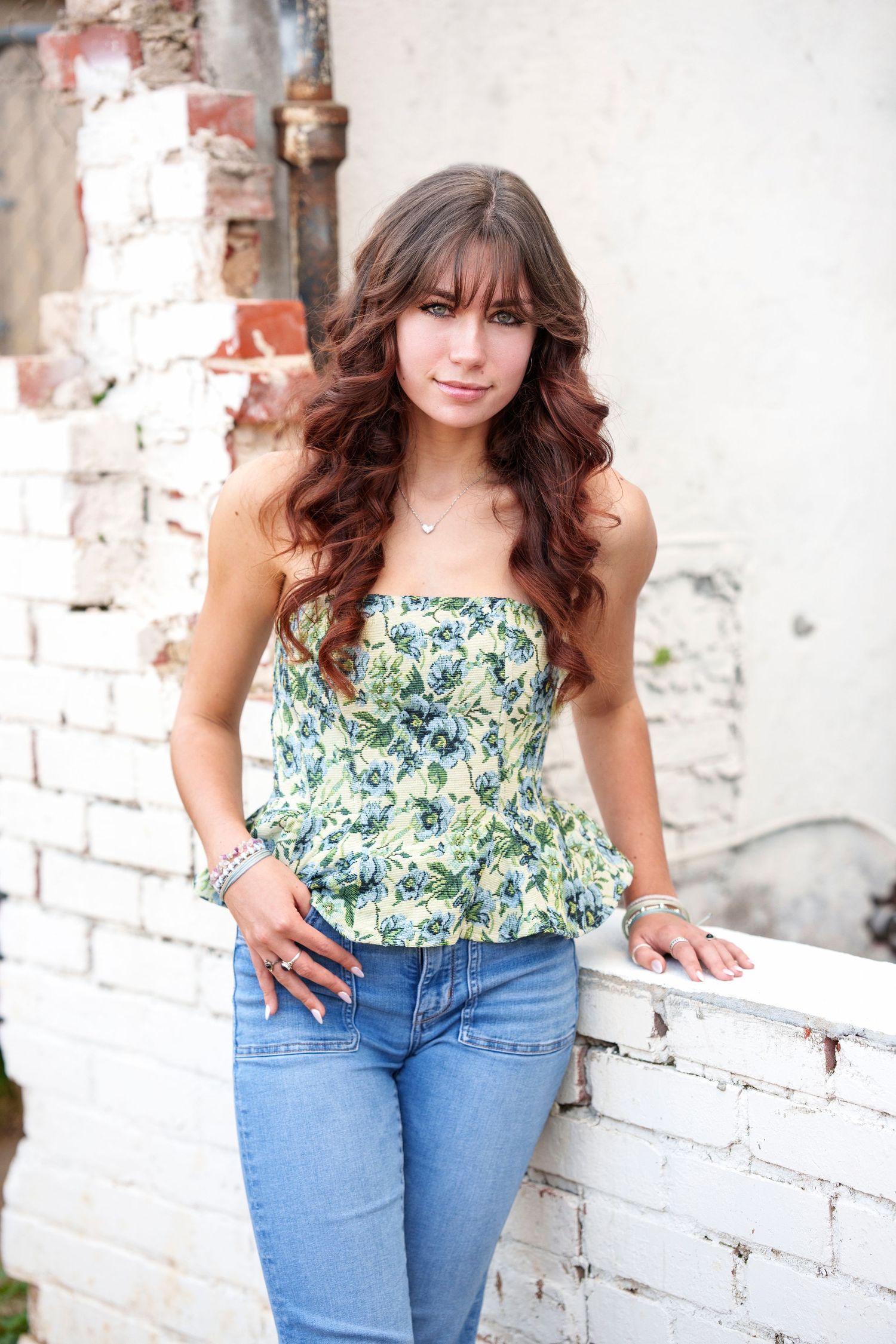 The Woodlands senior photographer with white urban wall