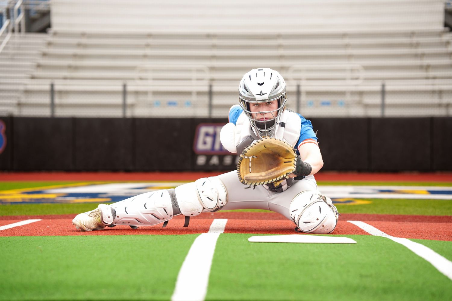 senior baseball photos of a catcher on the field in the woodlands and grand oaks. senior photos on a field.  baseball senior photos.