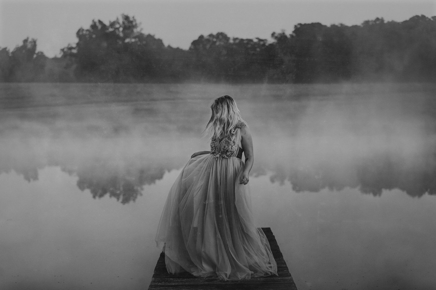 Woman in gown on misty lake — ethereal and cinematic, quiet morning light captured by ja'nicole;art