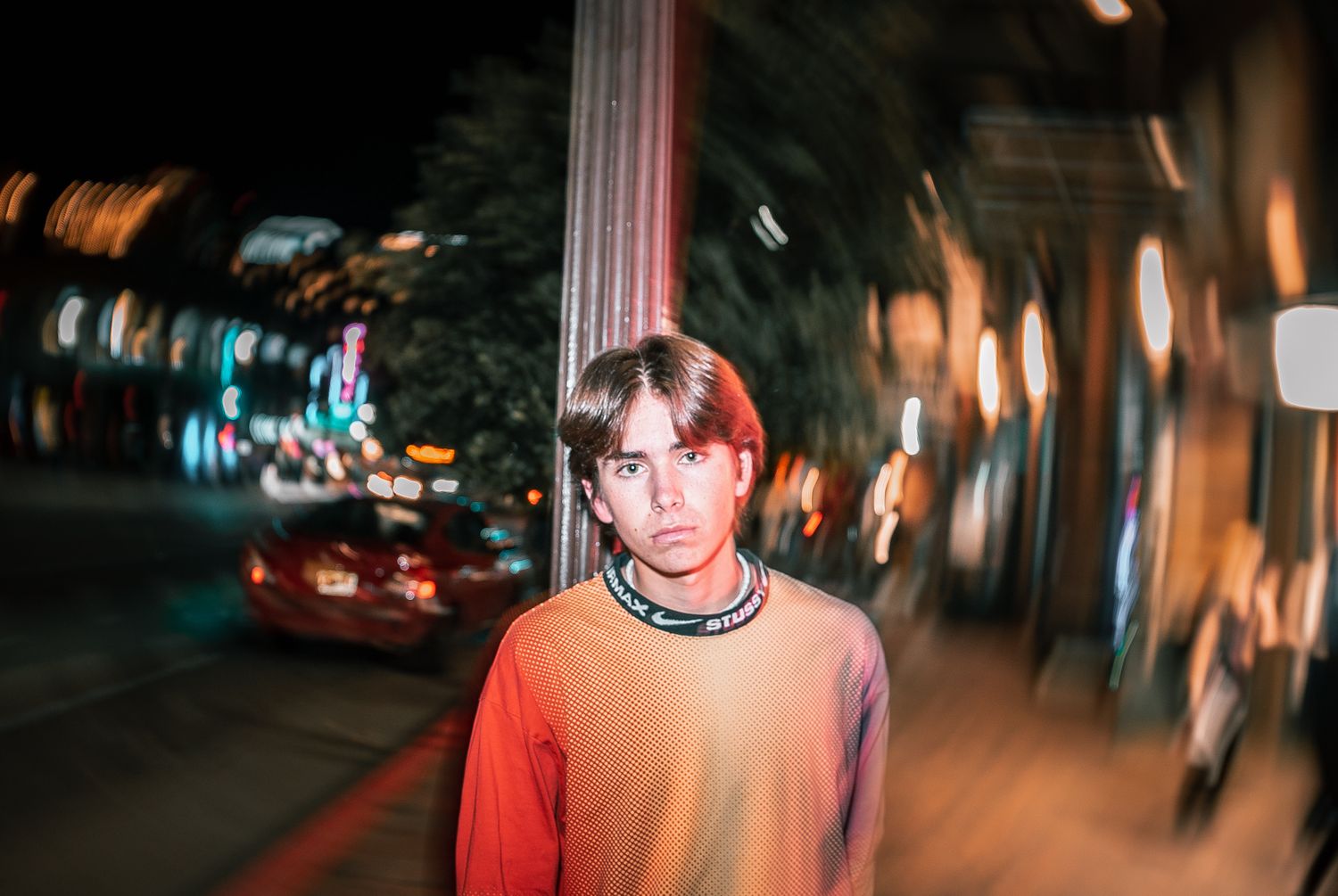 Nighttime street scene with motion blur and ambient lighting effects.