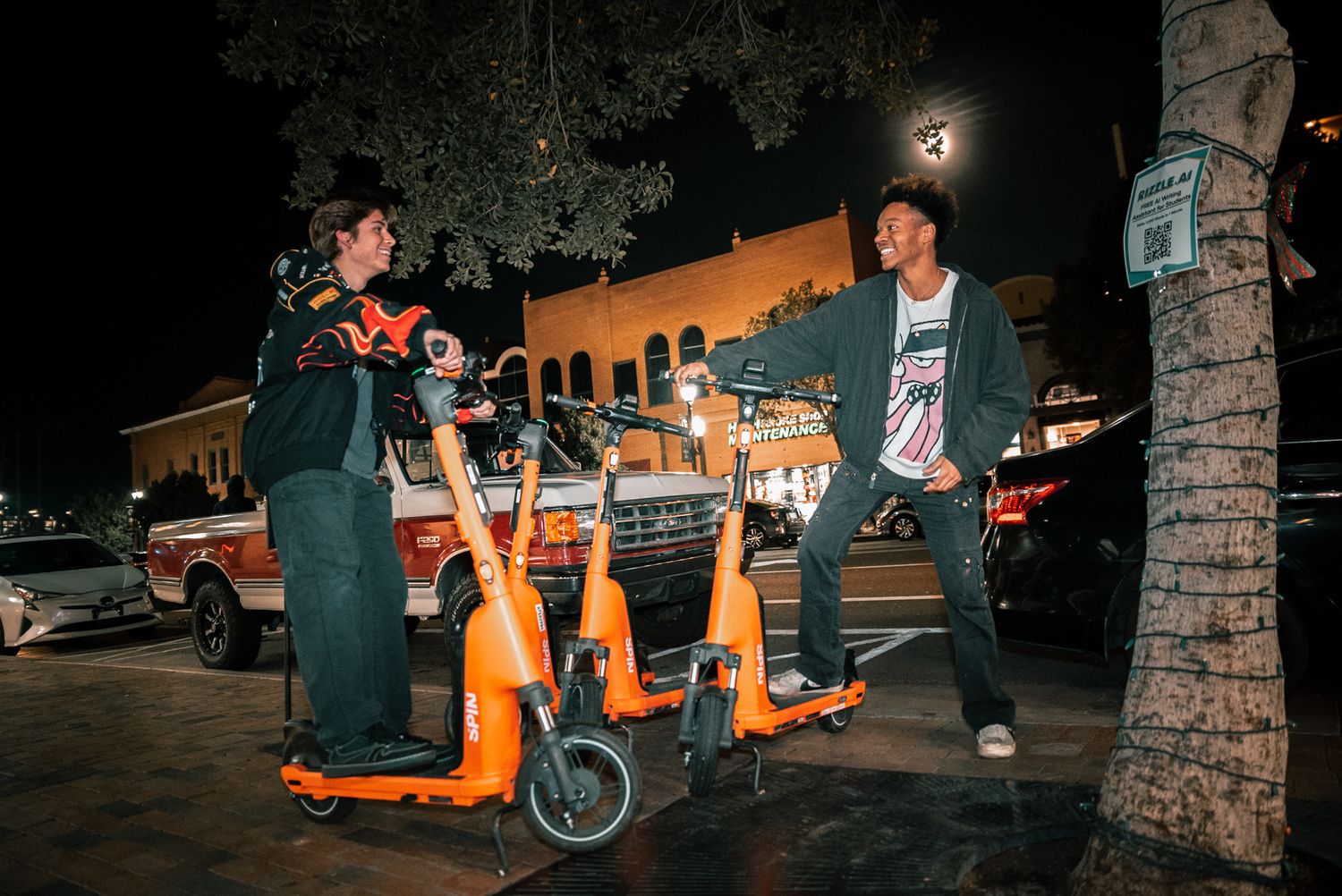 Nighttime scene with electric scooters and urban setting.