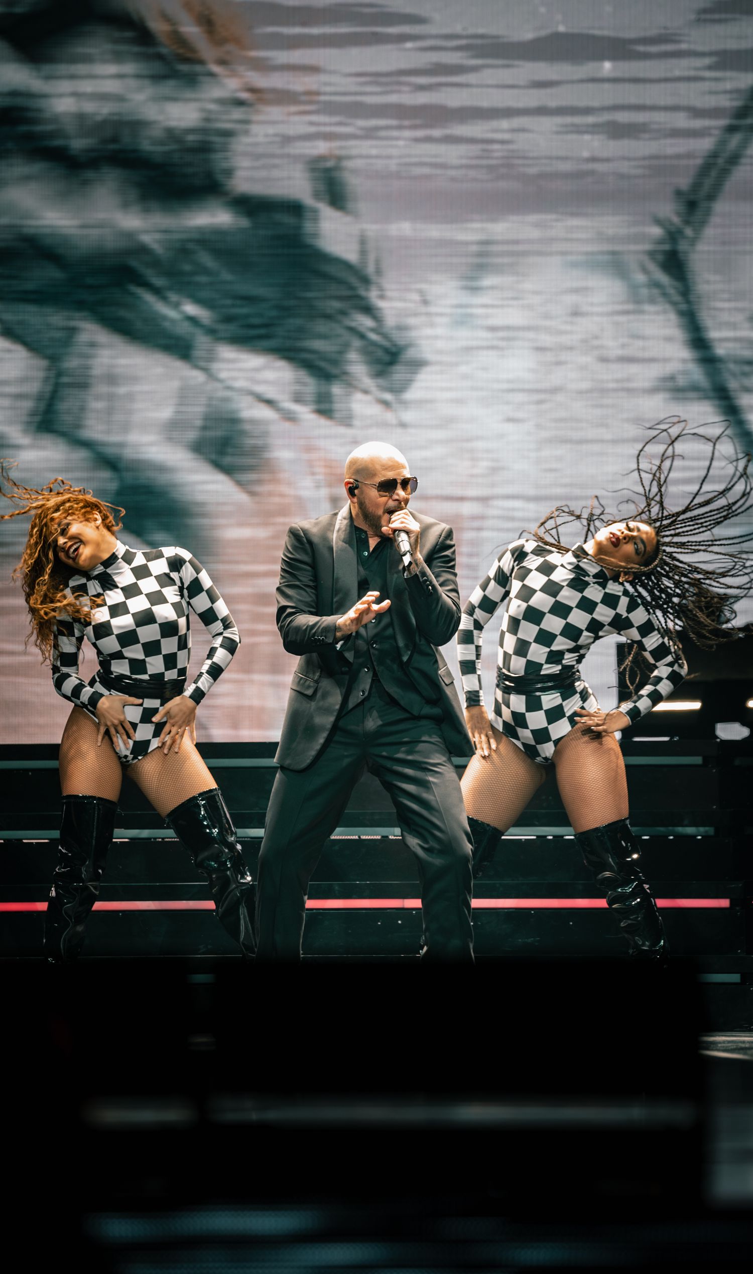 Energetic dance routine features dramatic poses and contrasting black and white stage costumes.