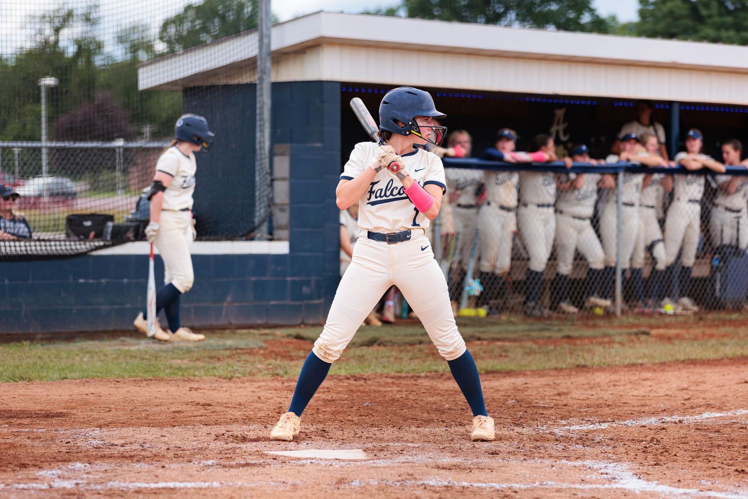 Baseball players in action during competitive game on diamond field.
