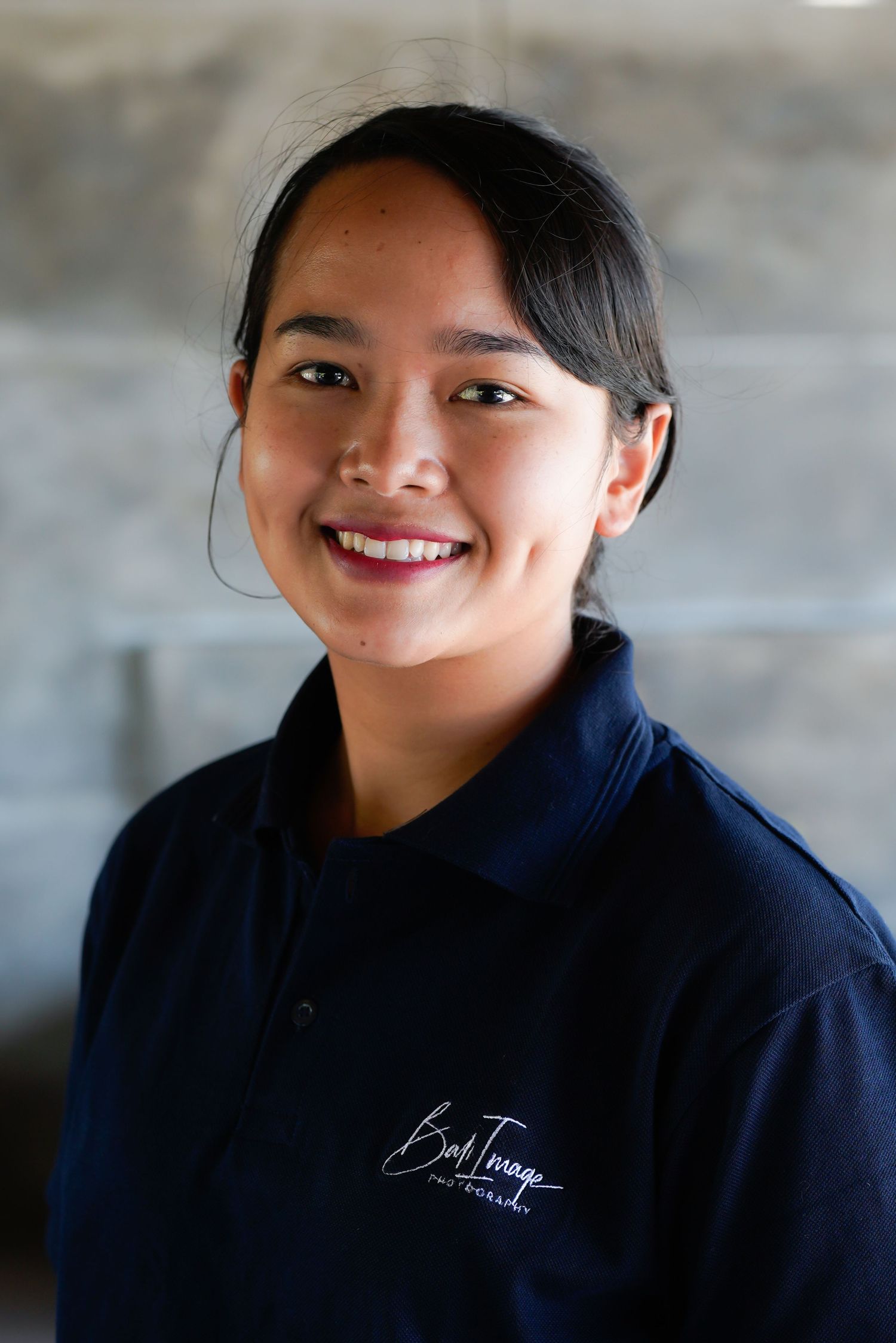 Series of cheerful expressions captured in professional headshots wearing dark uniform.