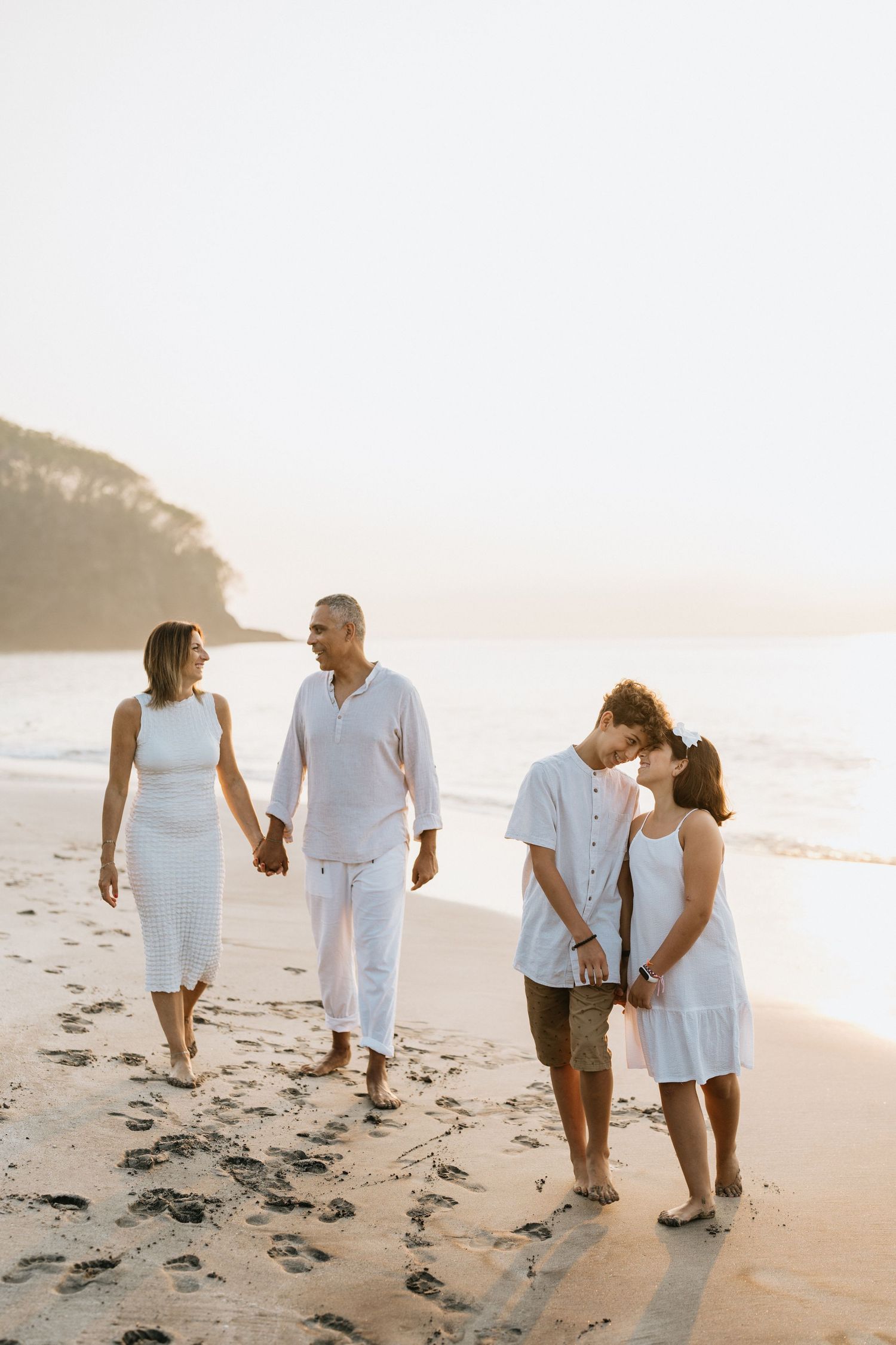 Beach family photography in Bali with an 
ocean backdrop