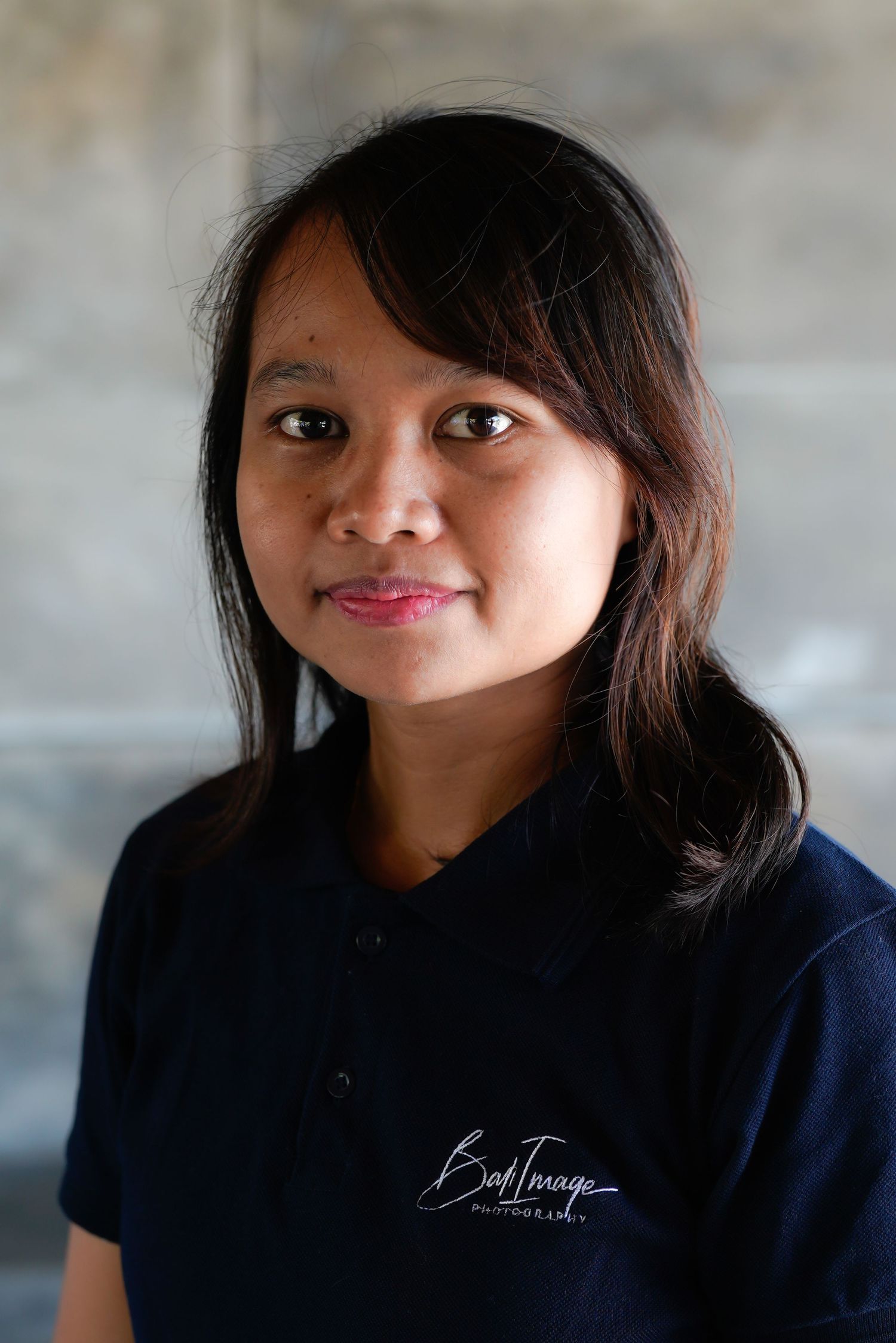 Portrait series showing friendly expressions and dark uniform against neutral background.