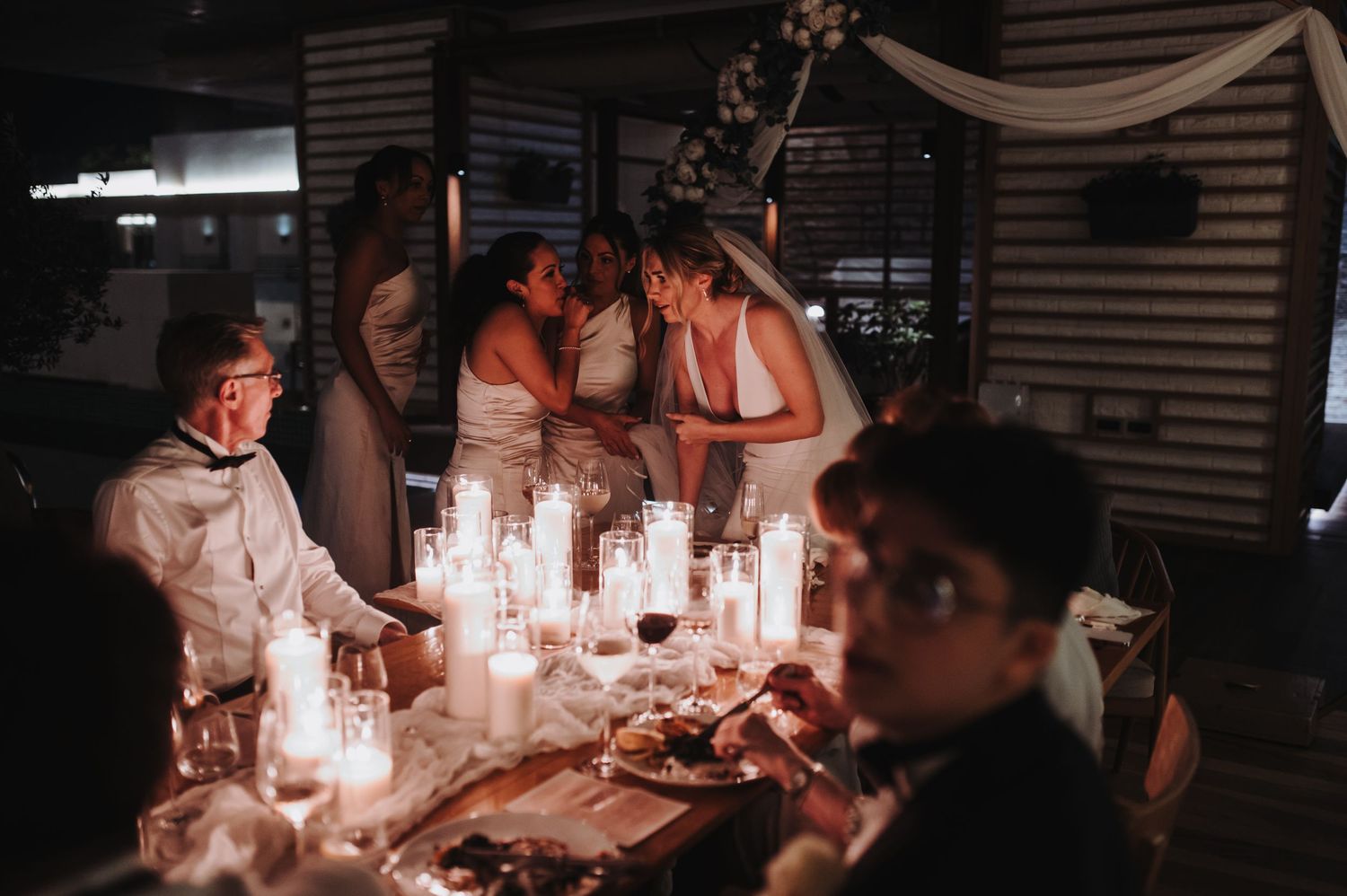 Candlelit wedding reception tables creating an intimate atmosphere.