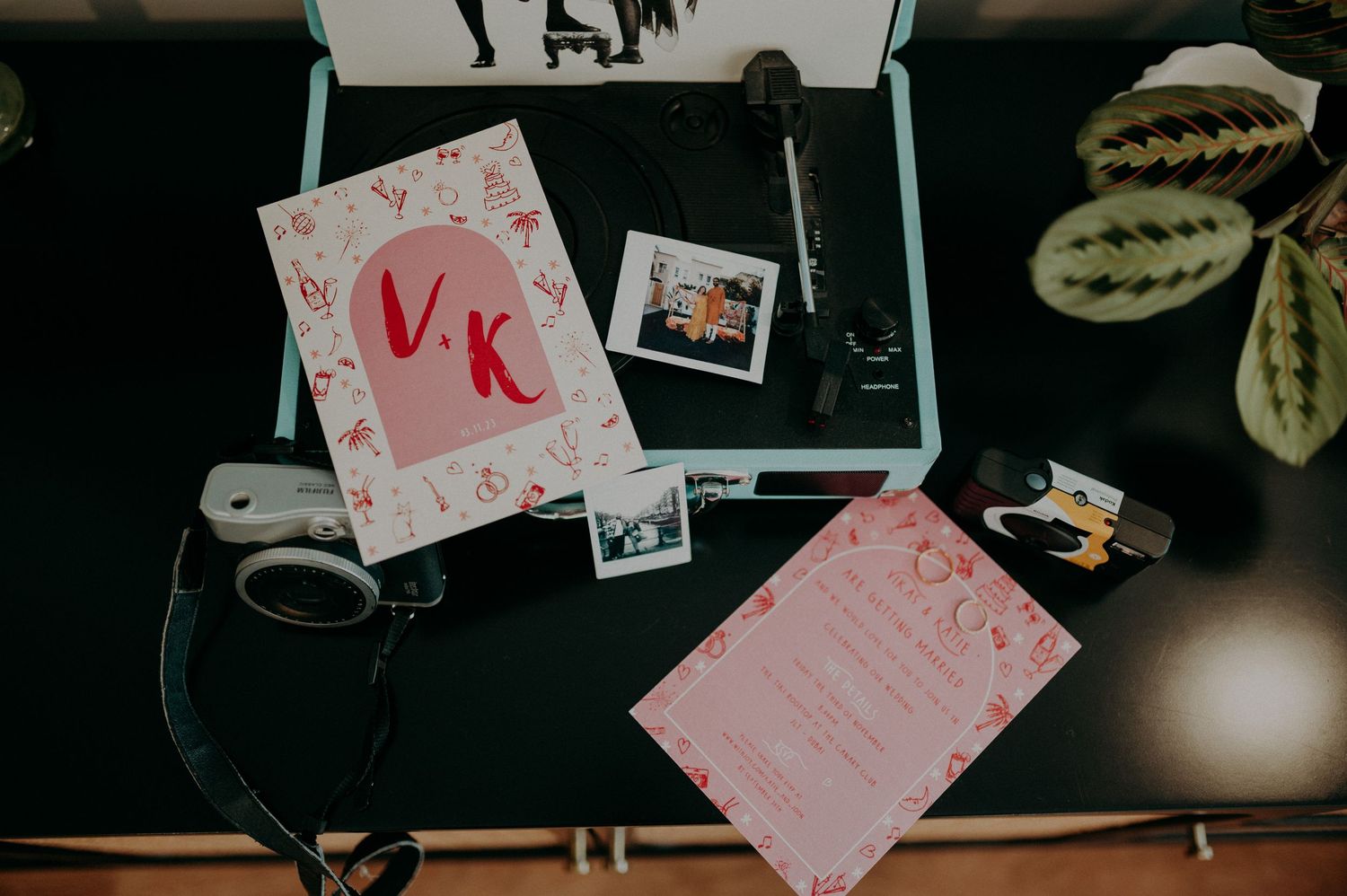 Dark moody photographs with pink accents and scattered polaroids on a surface.