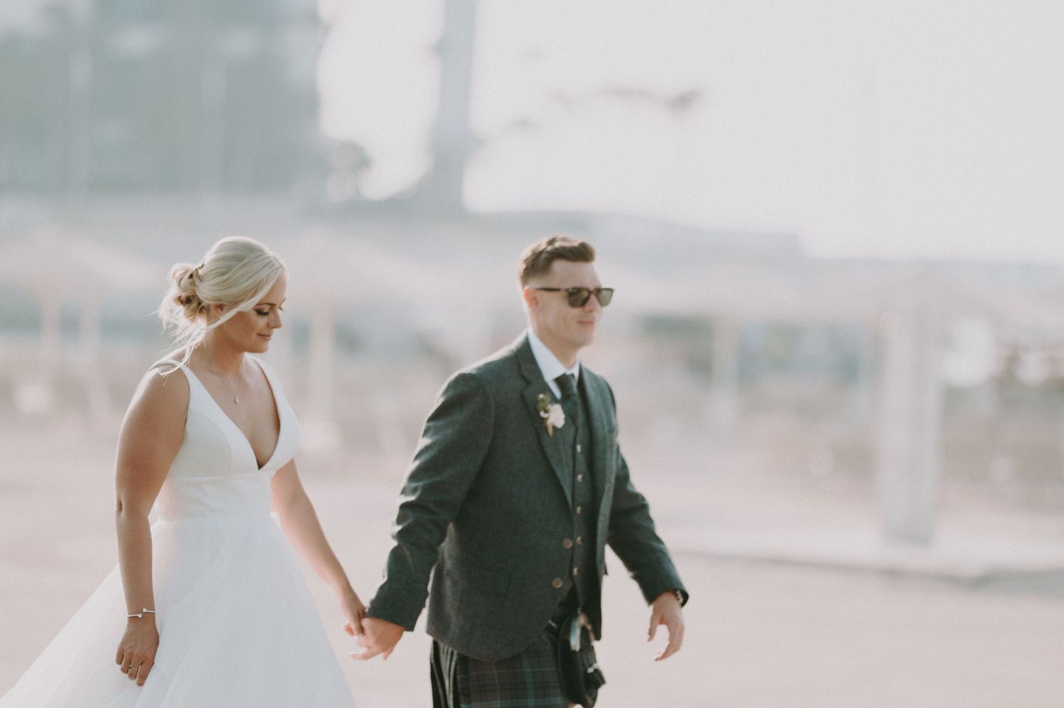 A romantic wedding photoshoot on a foggy beach with the couple in formal attire.