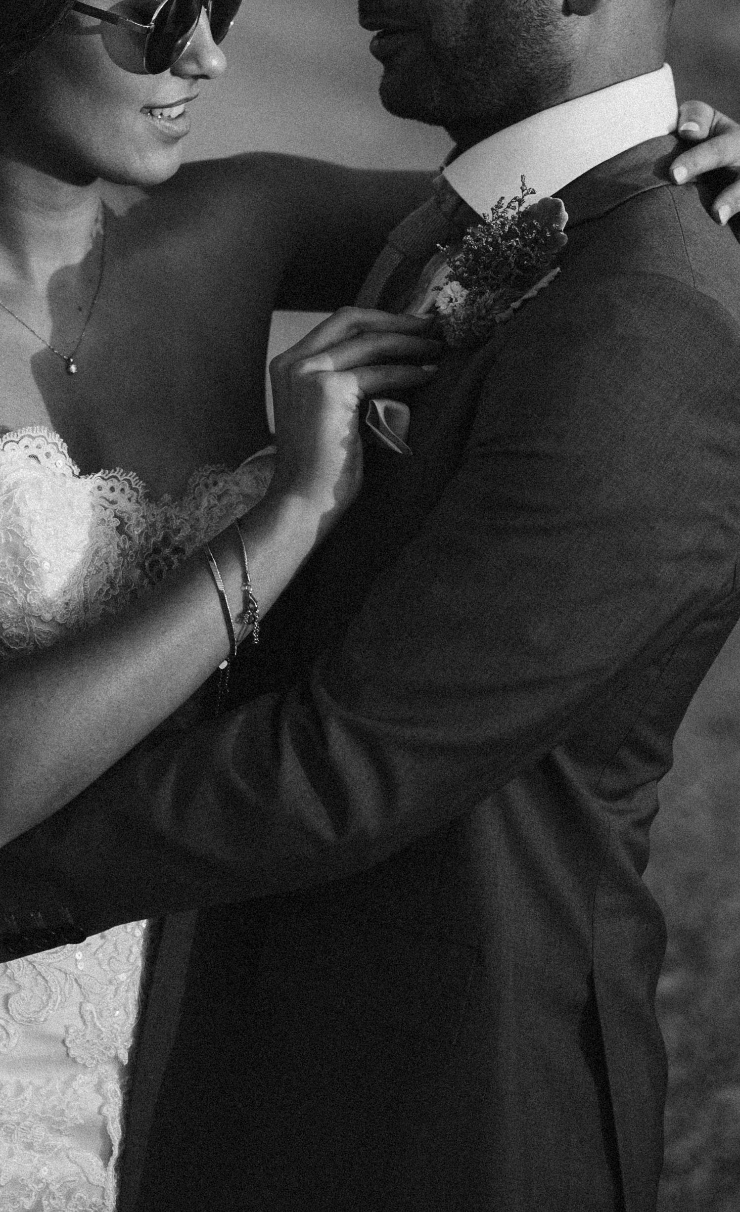 Black and white close-up details of formal wedding attire and intimate moments.
