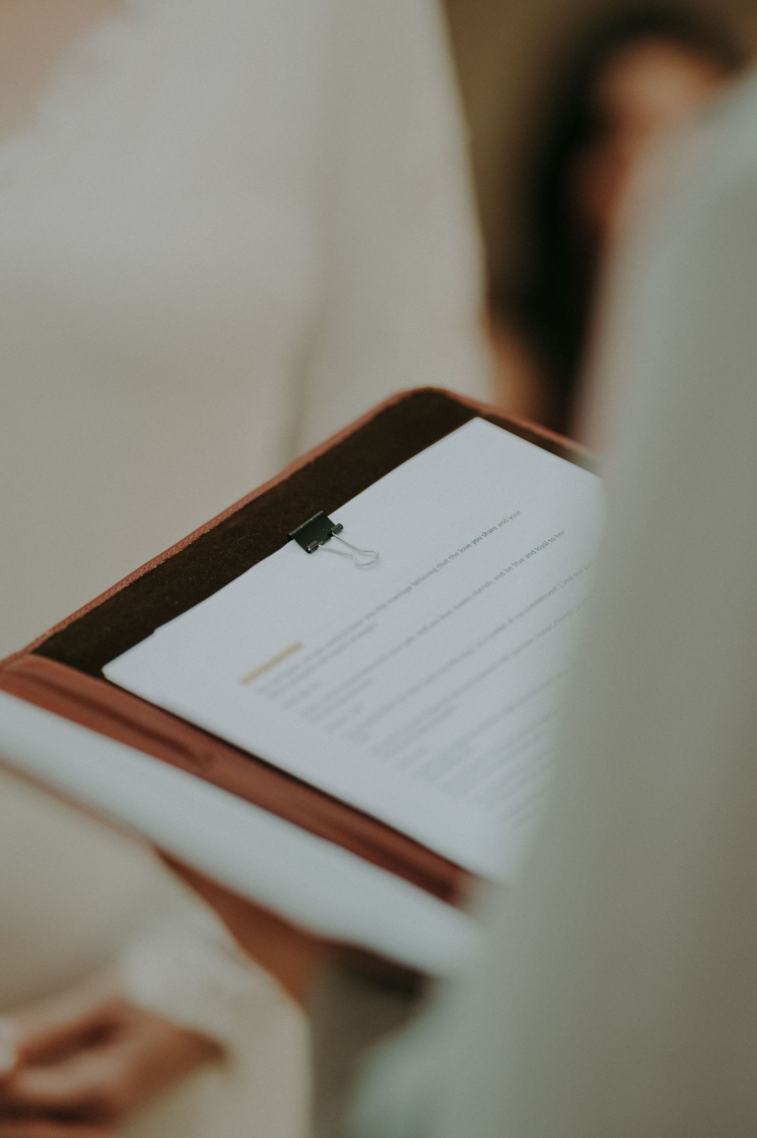 Close-up shot of wedding ceremony documents being read.