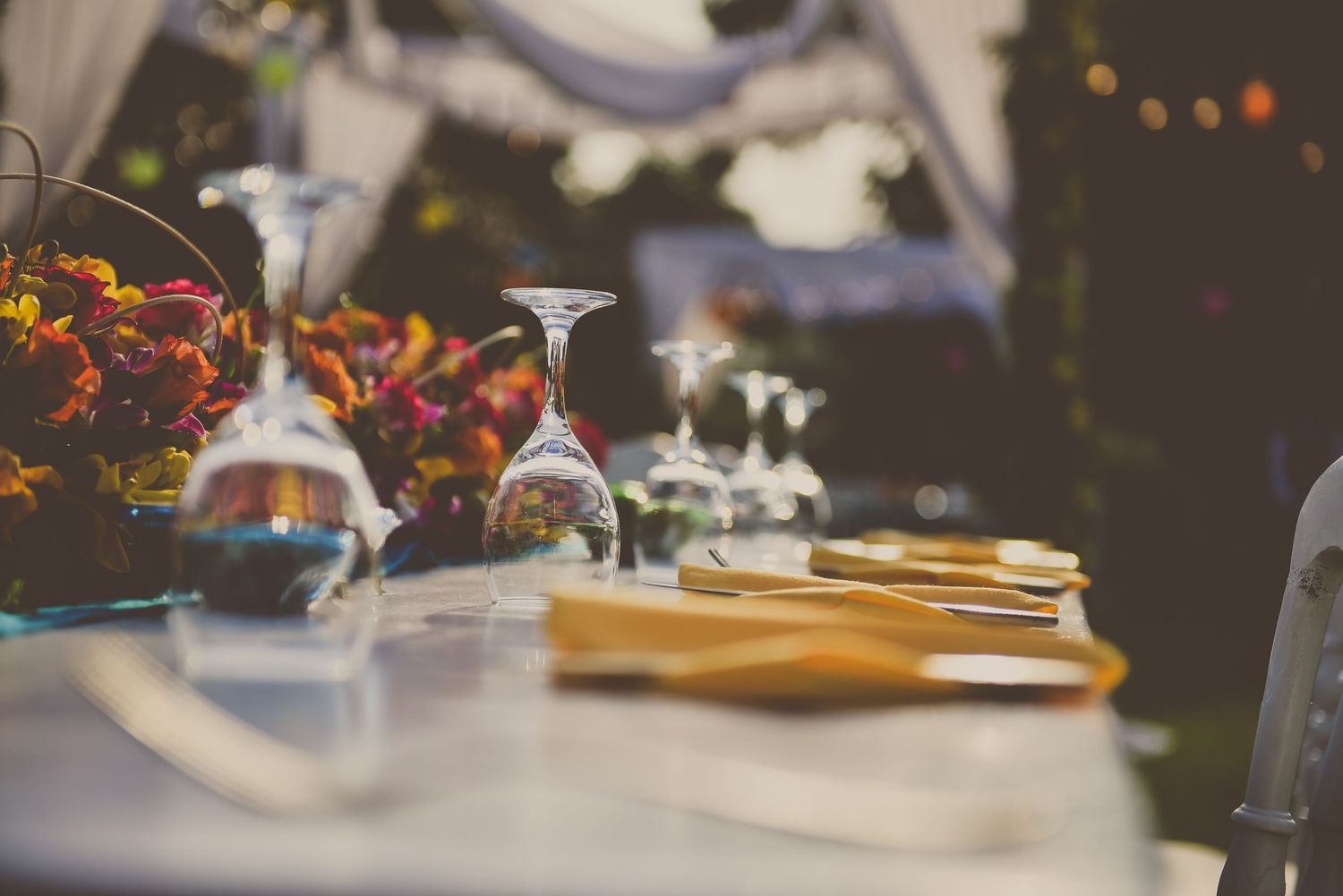Wedding reception table settings with elegant decor and floral arrangements.