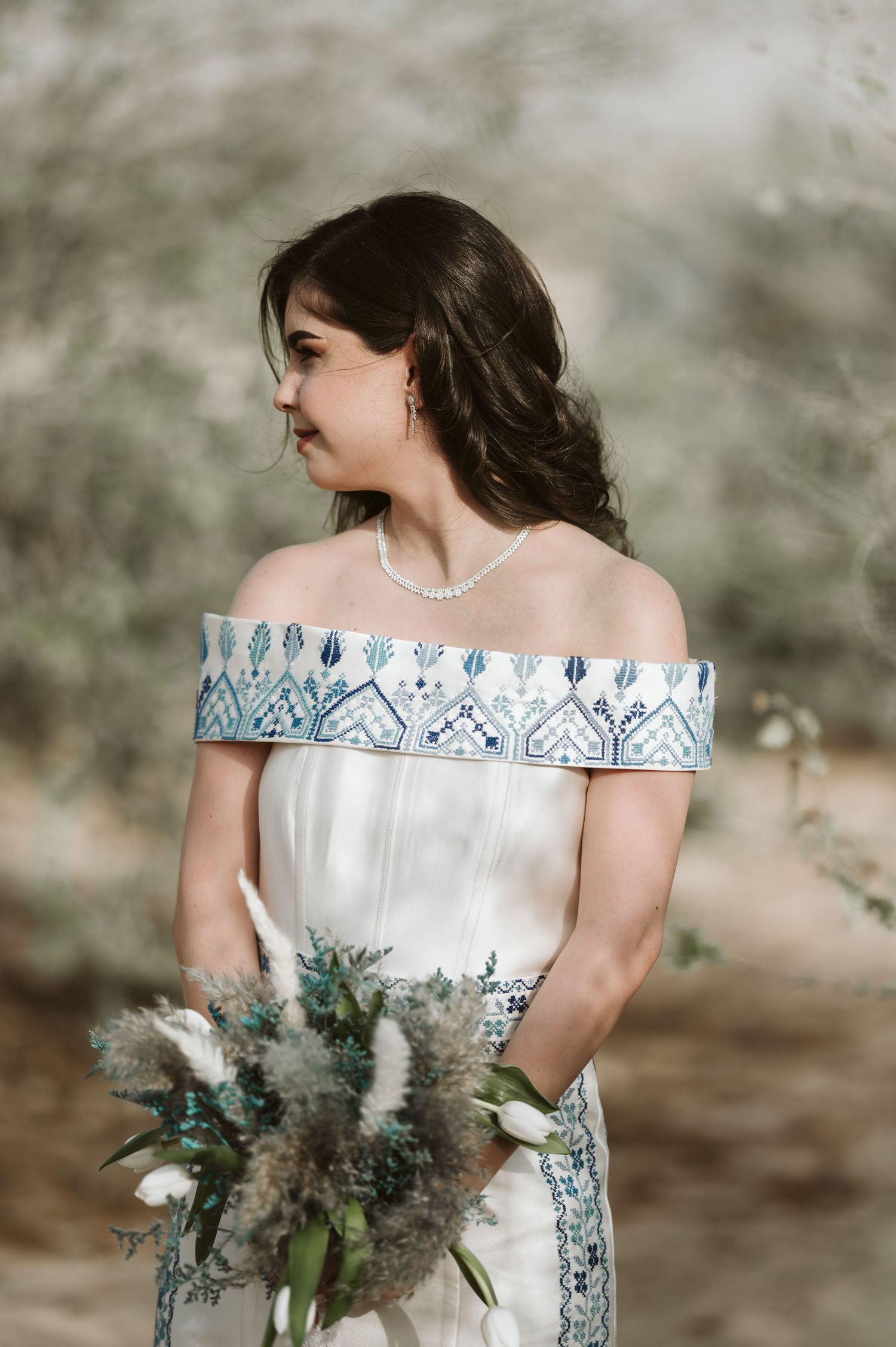 Elegant bridal session featuring an off-shoulder gown and textured floral bouquet.