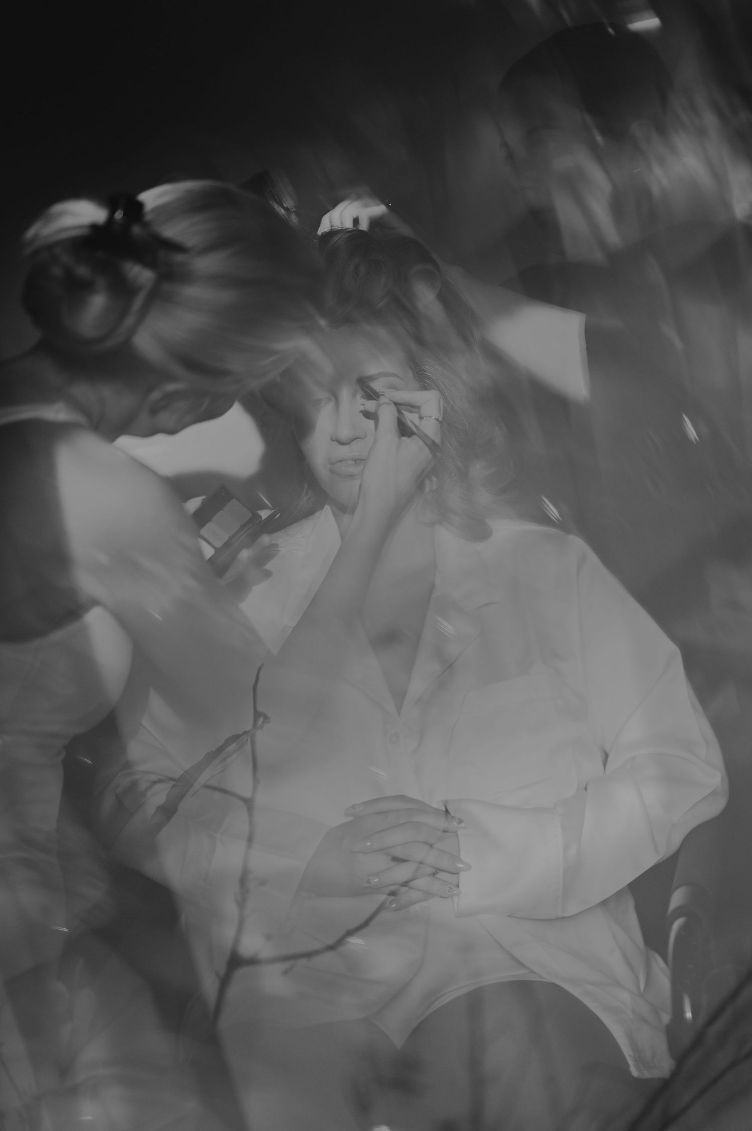 Black and white motion blur photographs creating an ethereal effect with flowing white fabric.