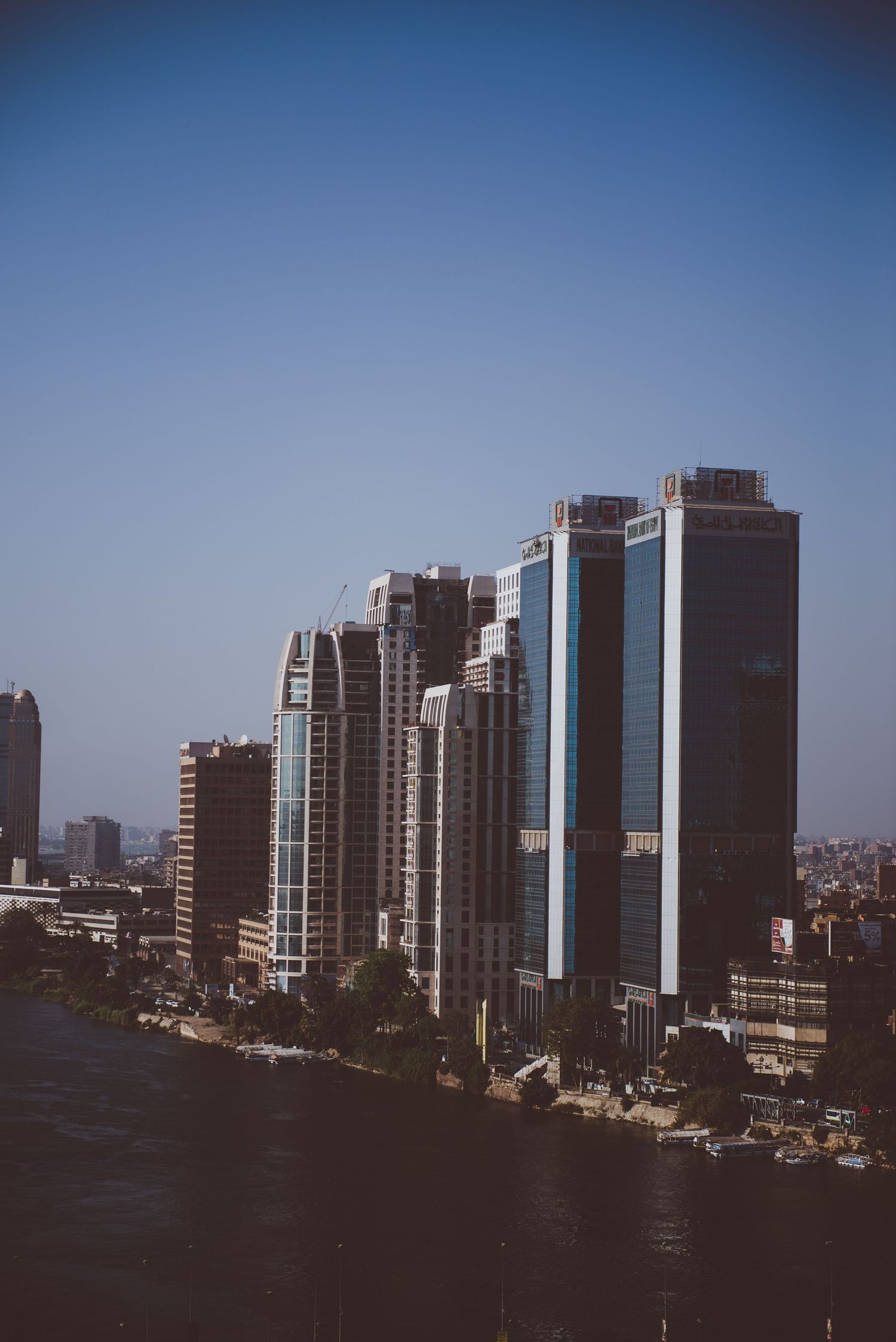 Modern urban skyline with high-rise buildings against clear blue sky.
