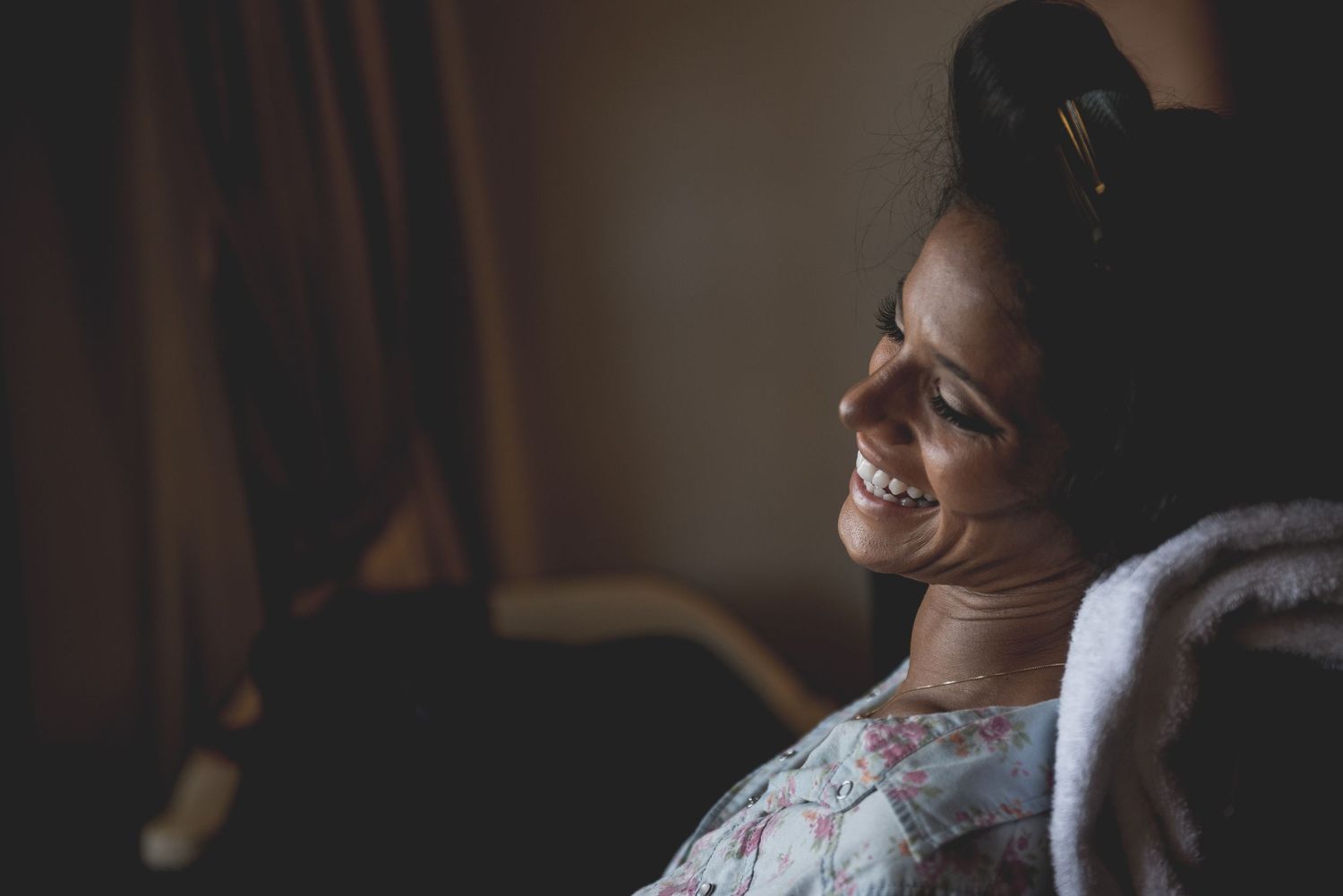 Candid moments captured in moody lighting during an indoor celebration.
