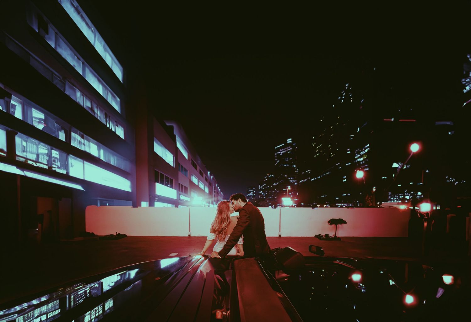 Urban nighttime cityscape with red and blue light trails.