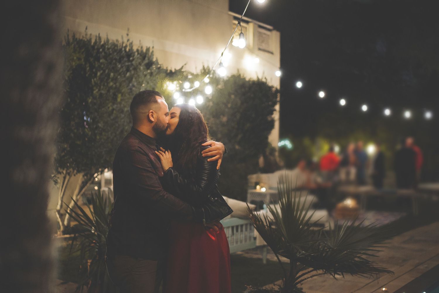 String lights create a magical ambiance at an outdoor evening celebration.