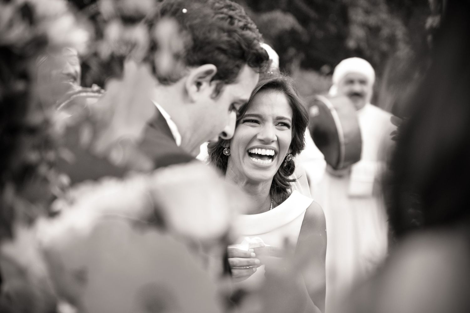 Black and white wedding portraits showing joyful moments between newlyweds.