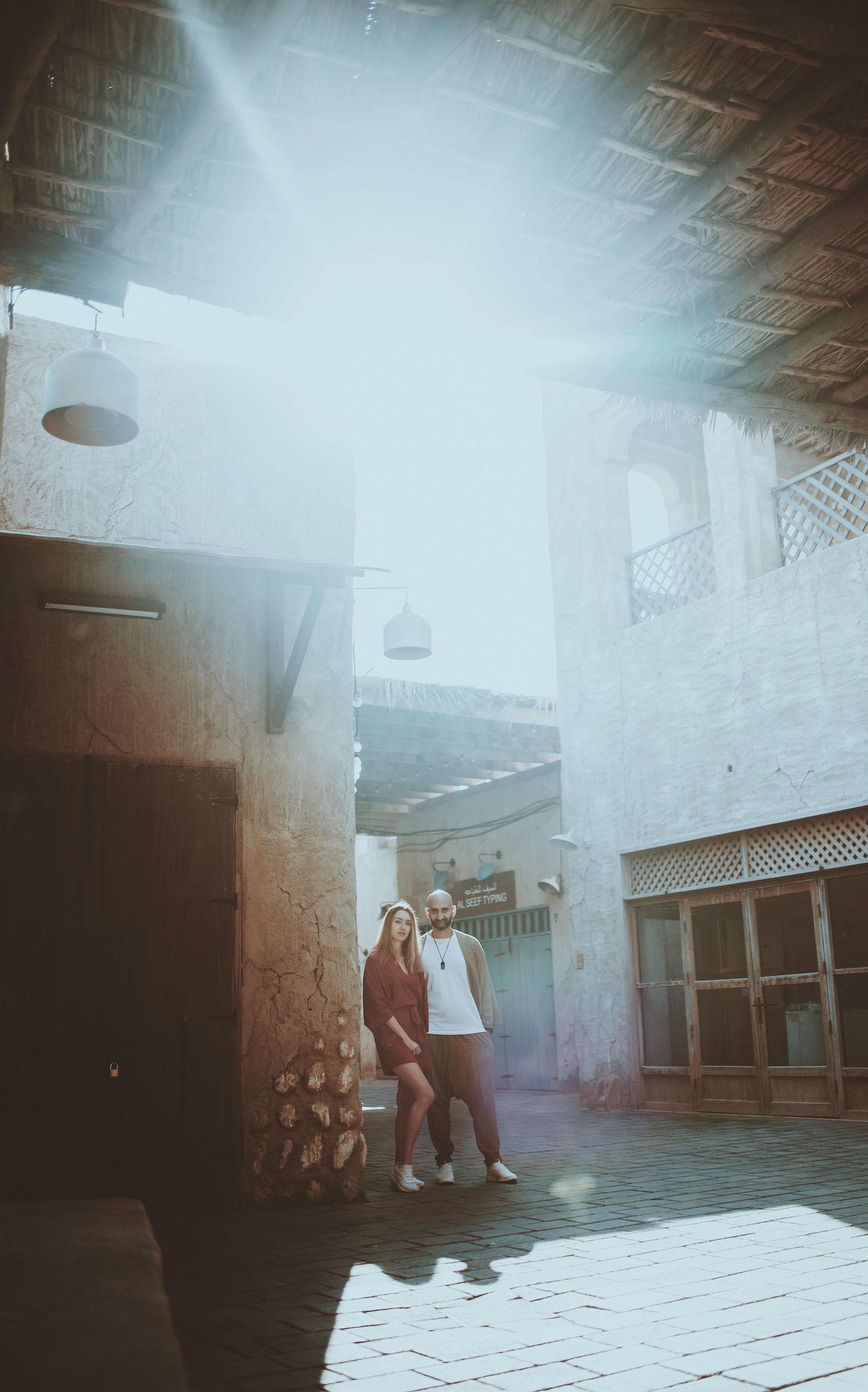 Atmospheric interior shot of a traditional building with sunlight streaming through windows.