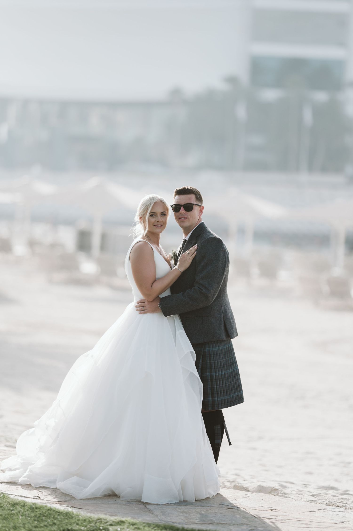 A couple shares a tender moment during their beach wedding photo session.