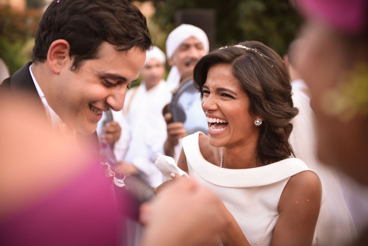 Joyful celebration with dancing and laughter at an outdoor event.