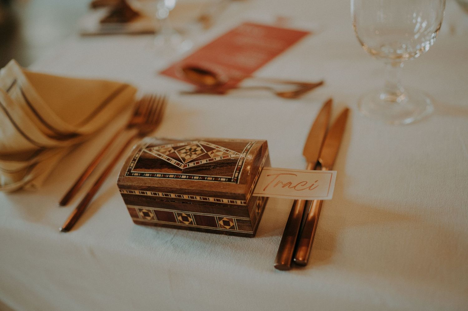 Vintage books and place settings arranged on a white tablecloth at a wedding reception.