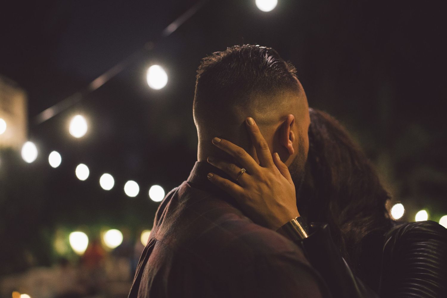String lights illuminate a romantic outdoor evening celebration.