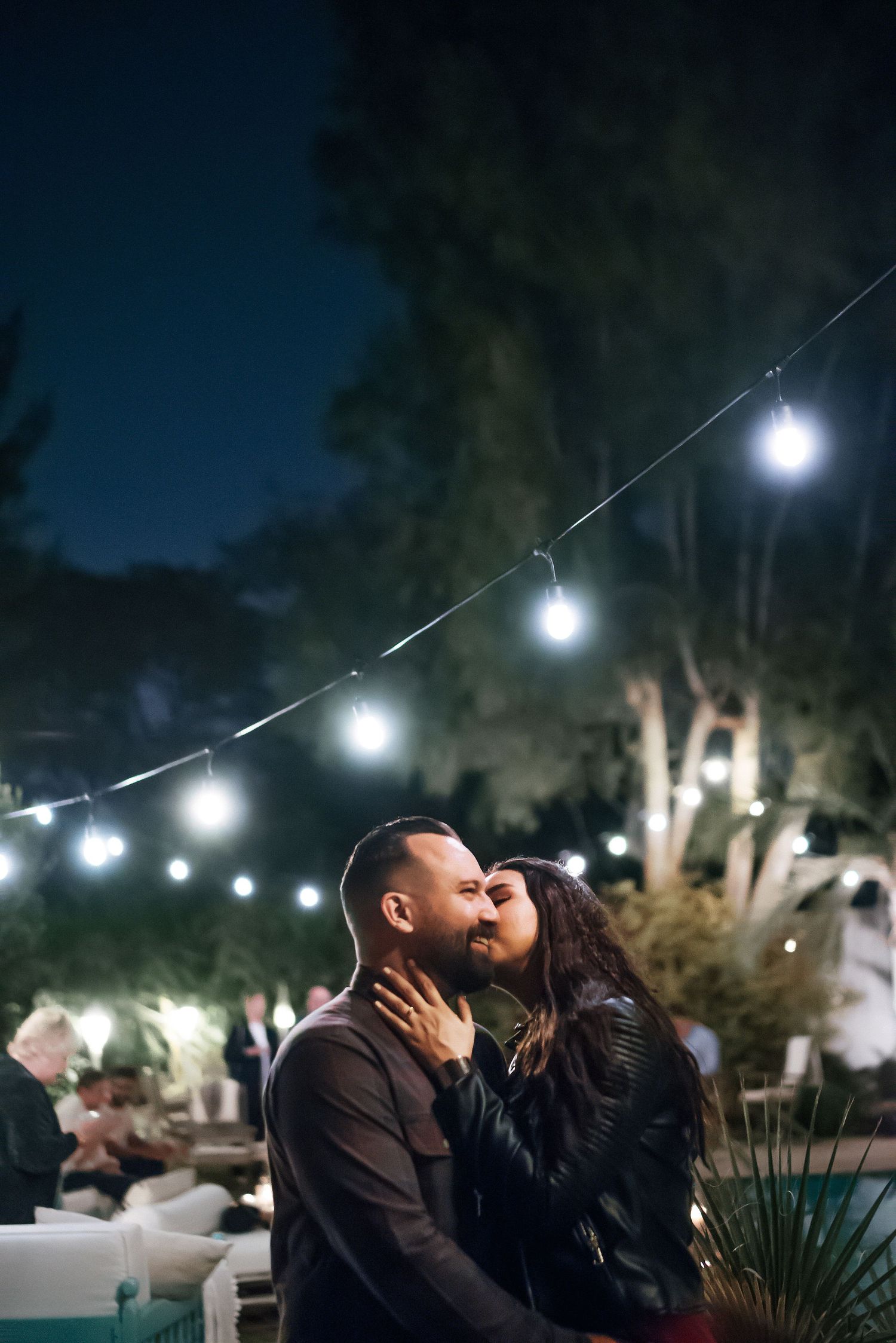 String lights create a romantic atmosphere in an outdoor garden setting at night.