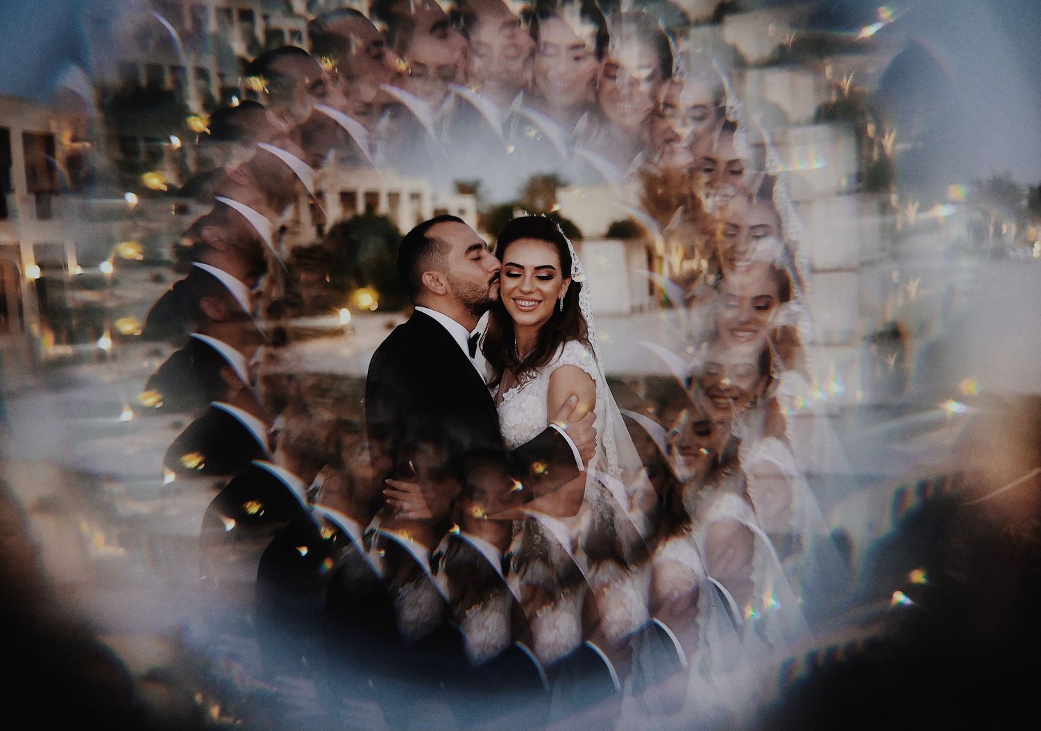 Blurred motion photograph of a crowded reception celebration with twinkling lights.