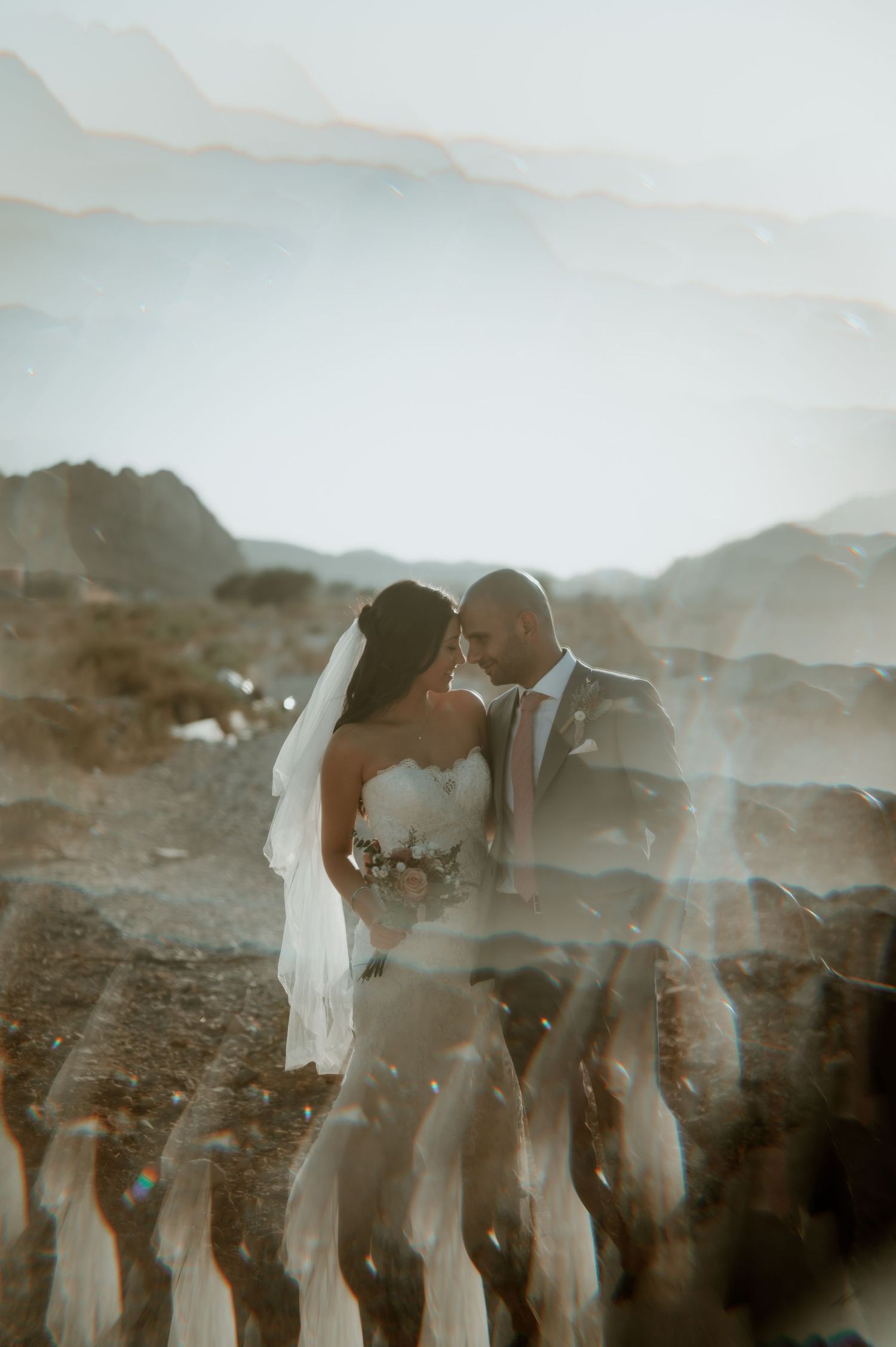 Multiple exposure wedding photo creating dreamy effect in desert setting.