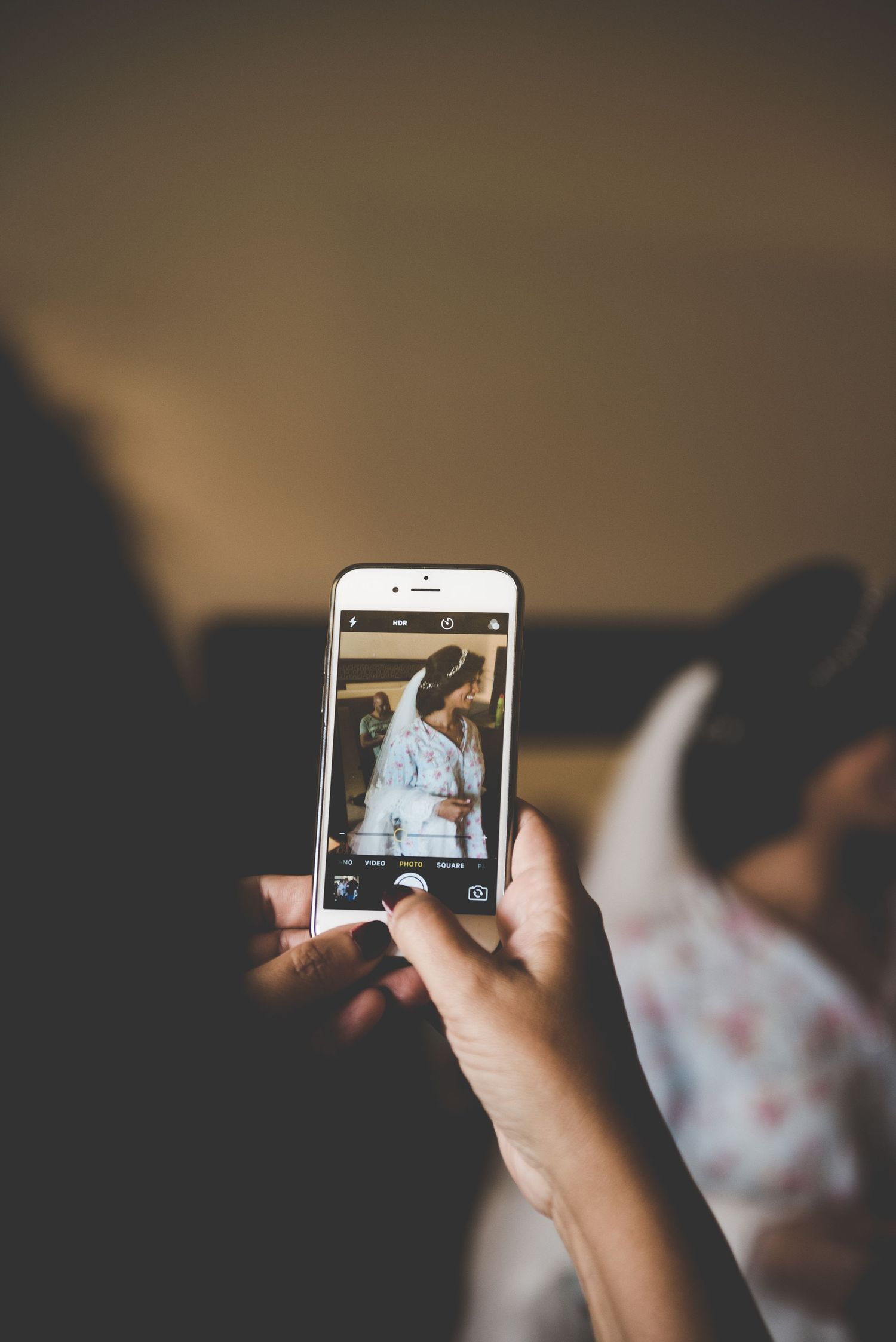 Hand holding smartphone displaying photo during editing or review session.
