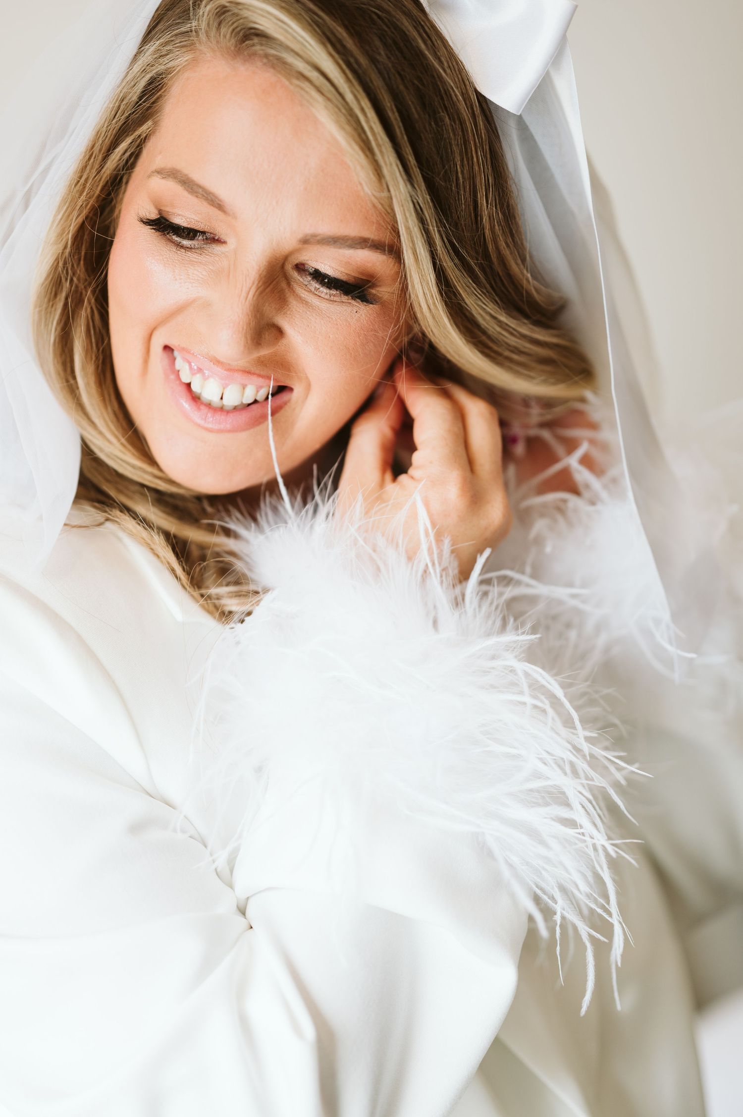 Close-up bridal portraits with feather details and soft, natural lighting.