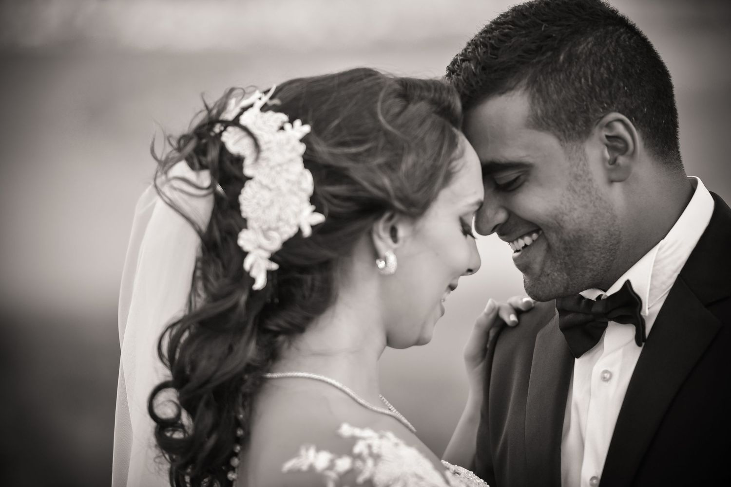 Romantic black and white wedding portraits capturing intimate moments between newlyweds.