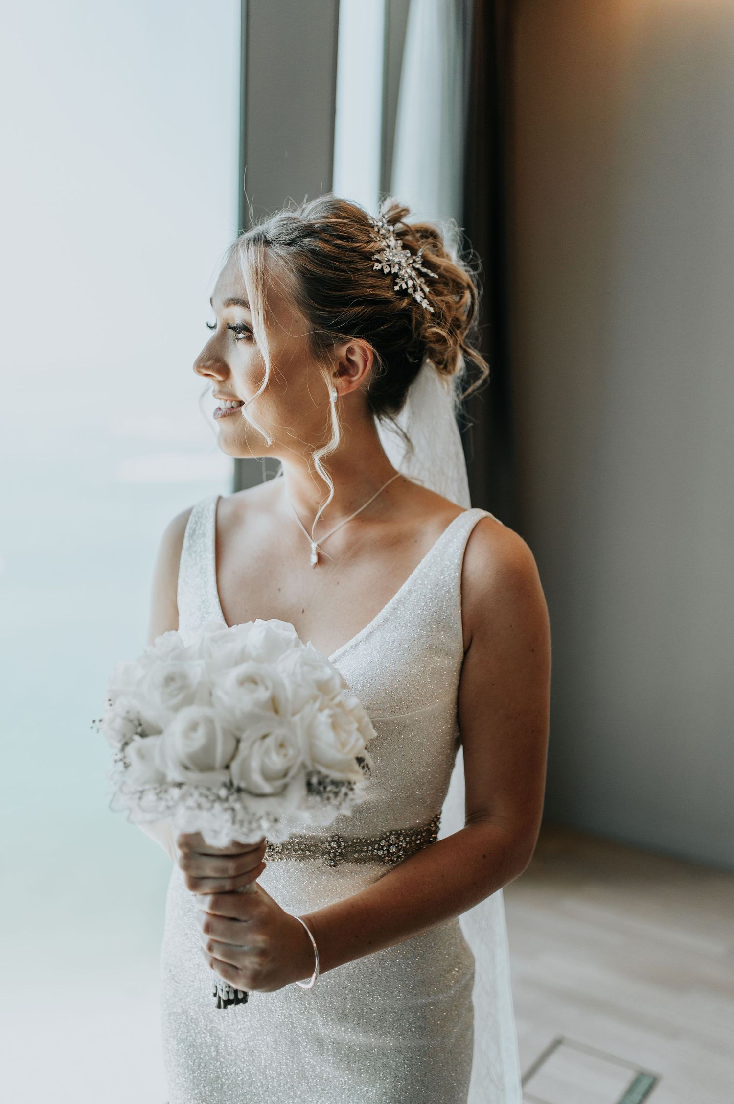 Close-up of a wedding dress with delicate beading and crystal embellishments.