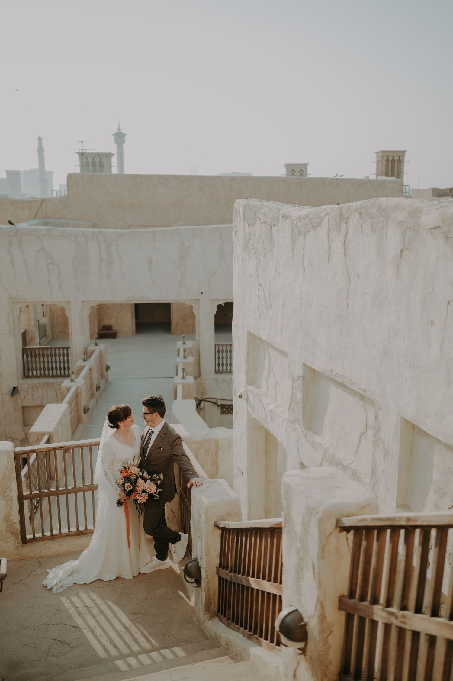 Wedding photography session at white stone building with traditional architecture.