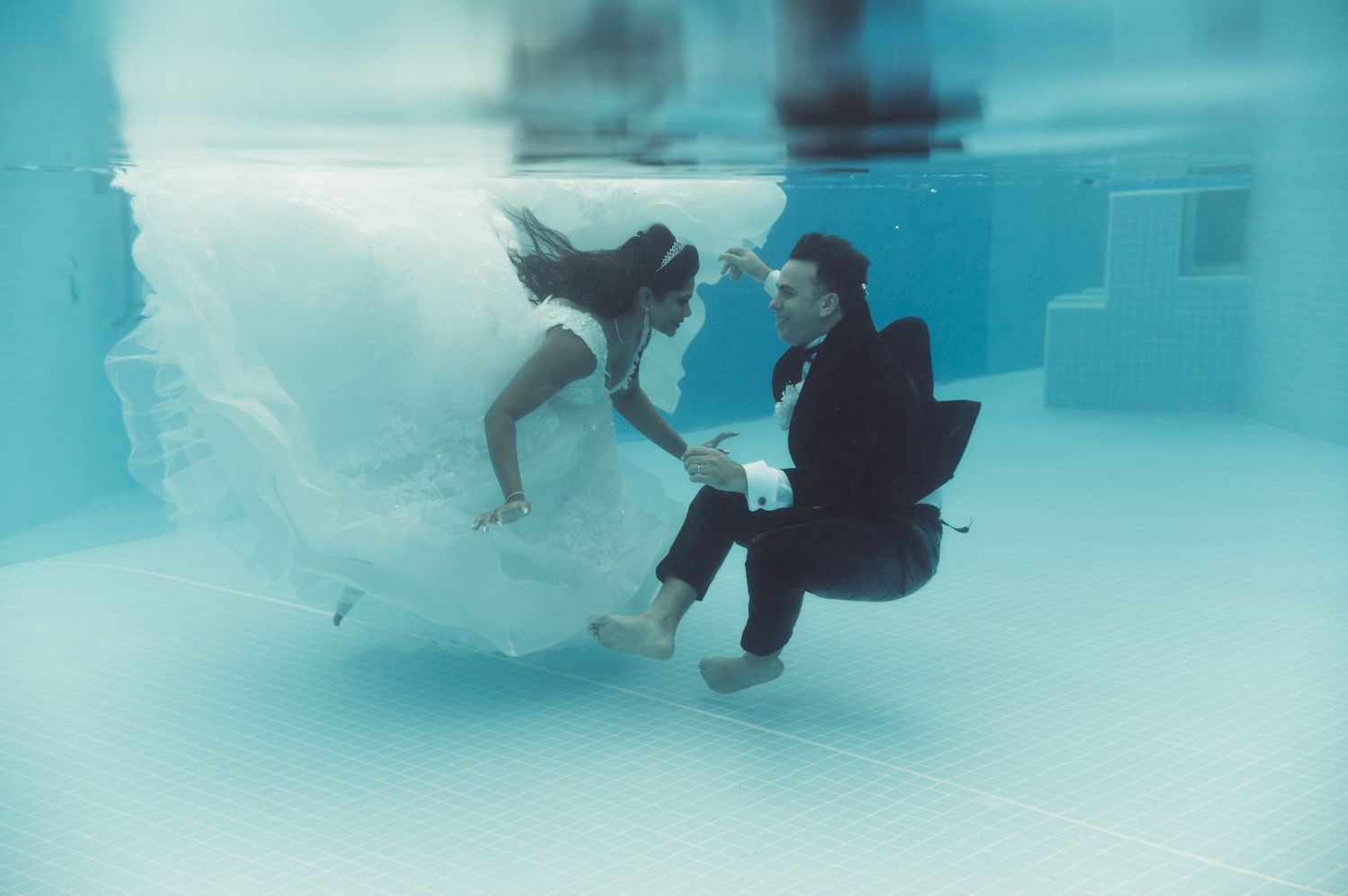 Series of underwater photos showing figures swimming in crystal clear blue pool water.