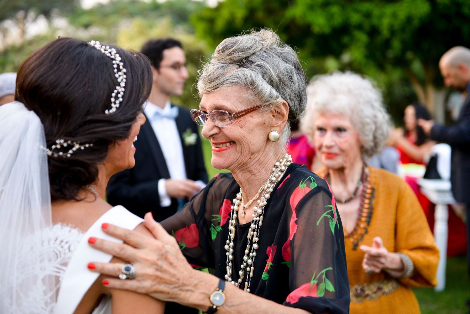 Wedding guests share joyful moments during an outdoor celebration.