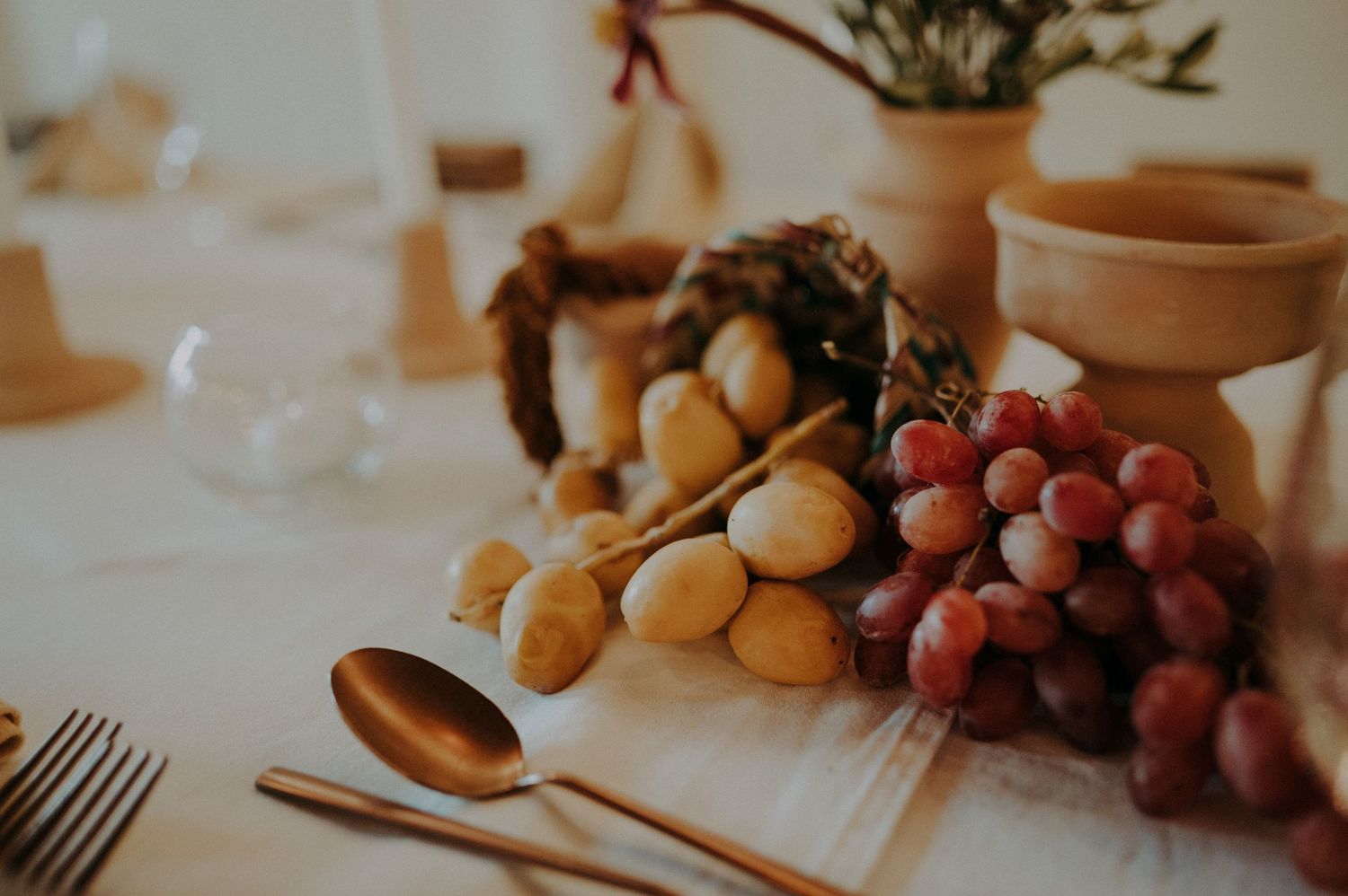 Wedding reception table with fresh fruit, bread, and rustic place settings.