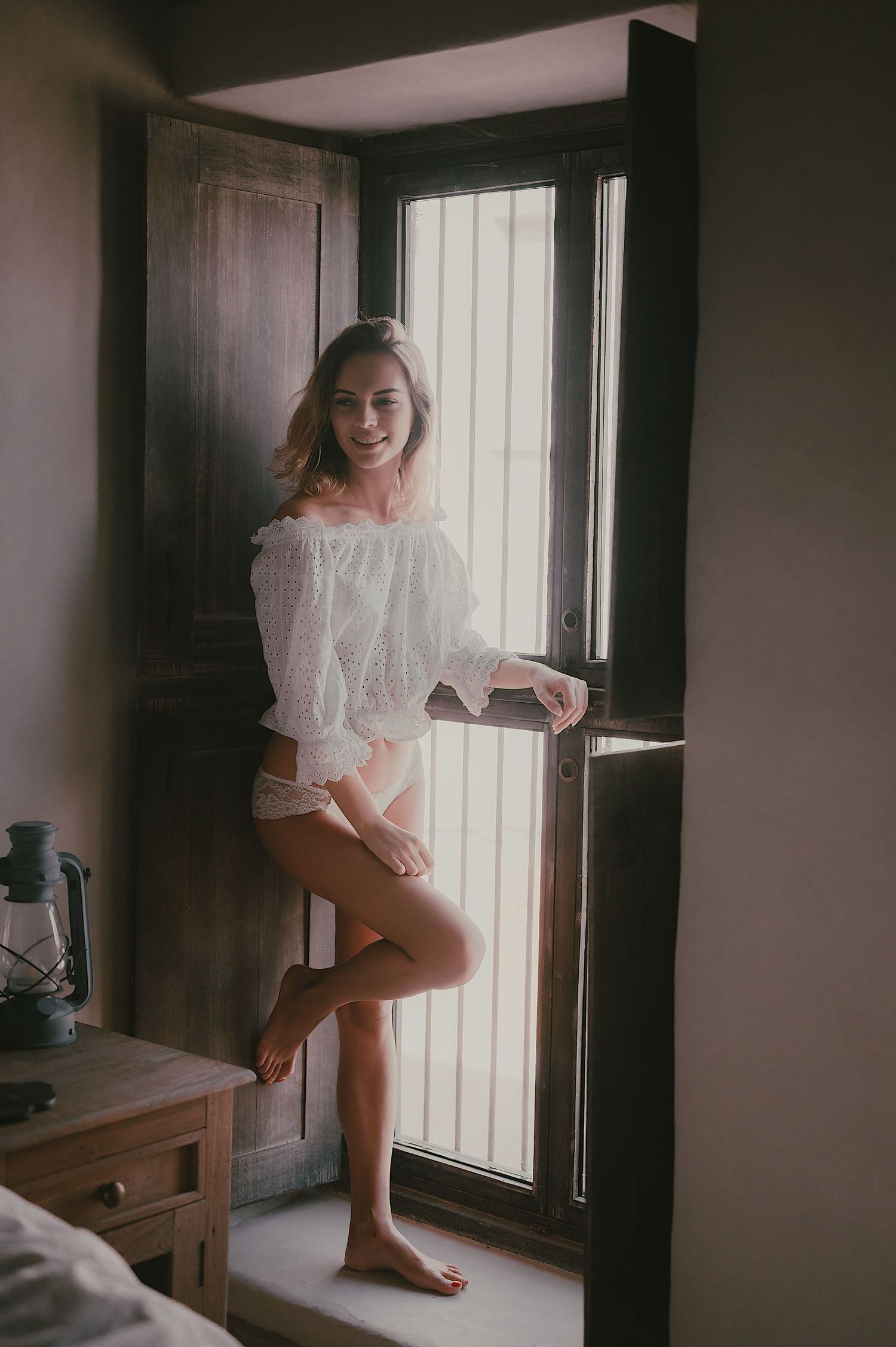 Artistic lifestyle portraits in a rustic interior with window lighting.