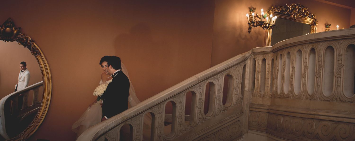 Warm lighting creates an elegant ambiance in a rustic venue setting.