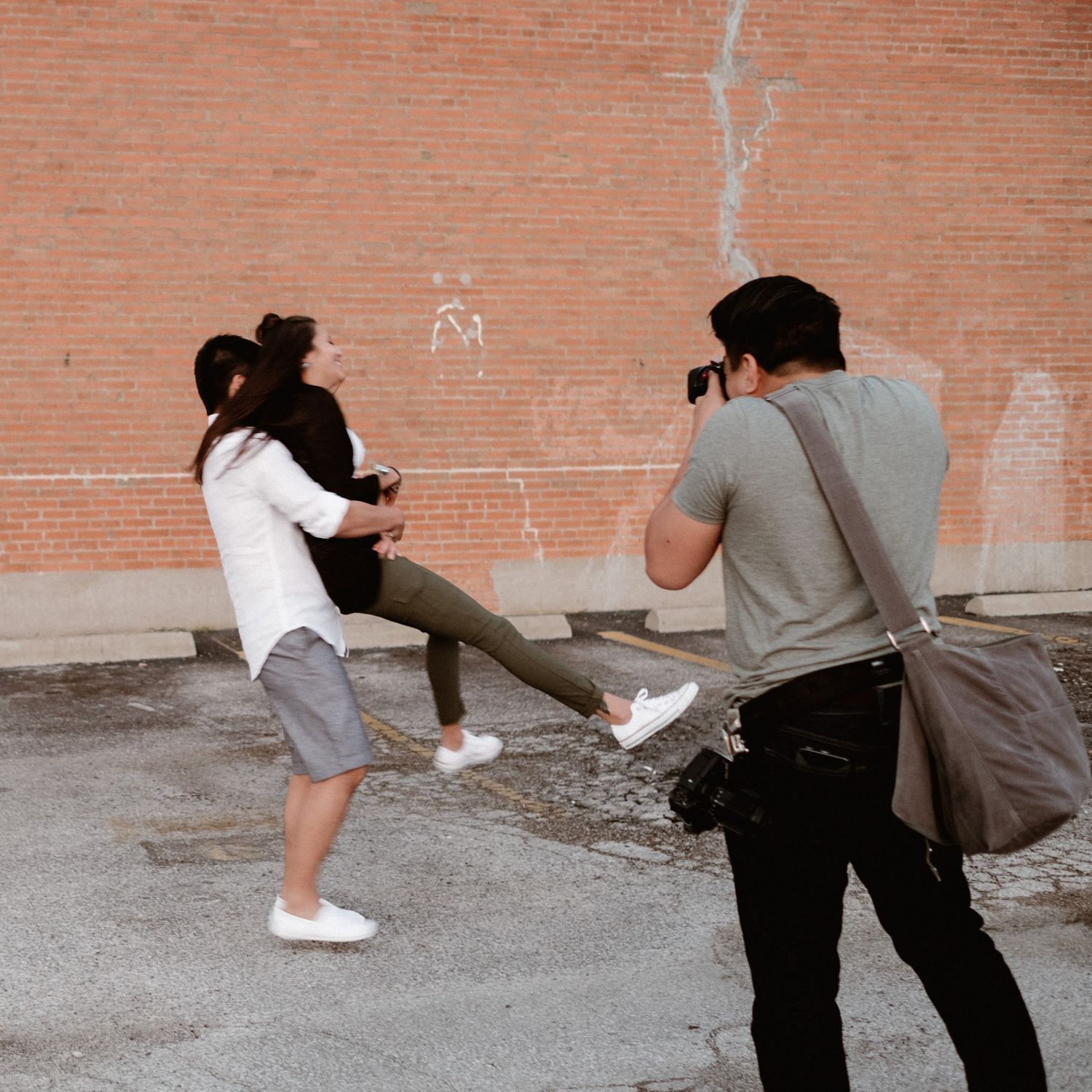 Photographers in action capturing shots against brick wall background. 
Jojo Pangilinan Photographers, Dallas based Destination wedding phot