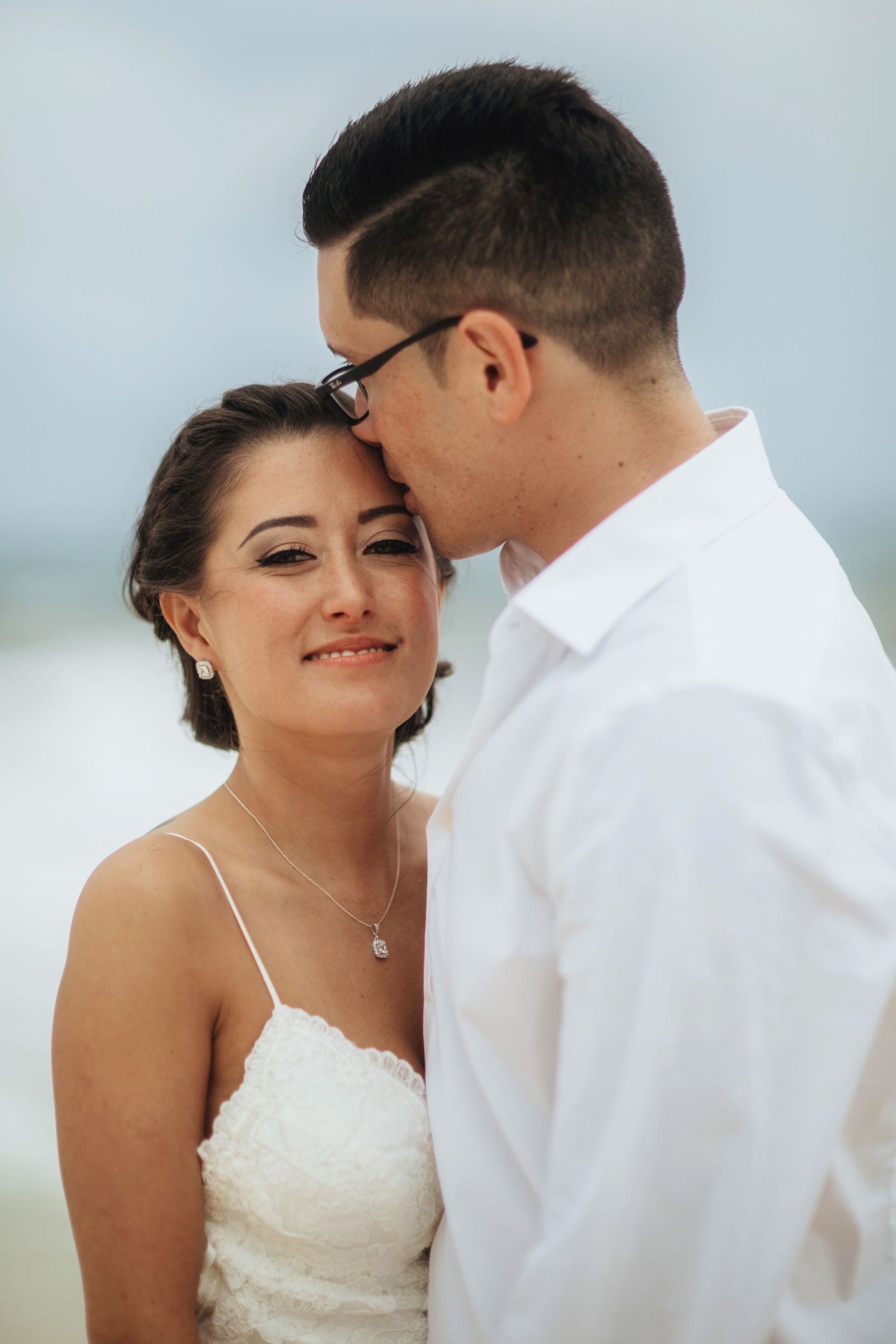 Close-up beach portraits with soft lighting and ocean background.
