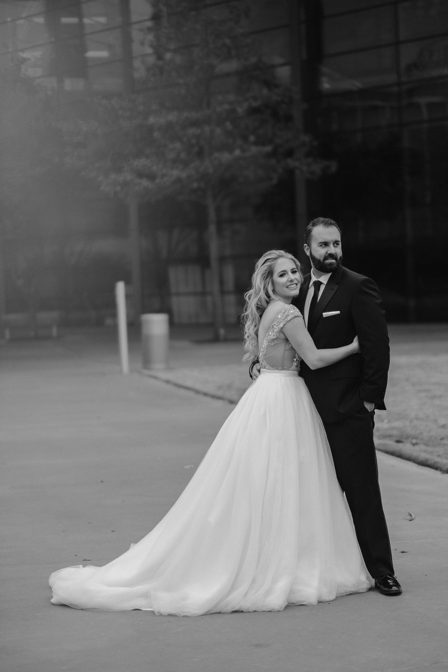 Black and white romantic dance sequence of a couple in wedding attire.