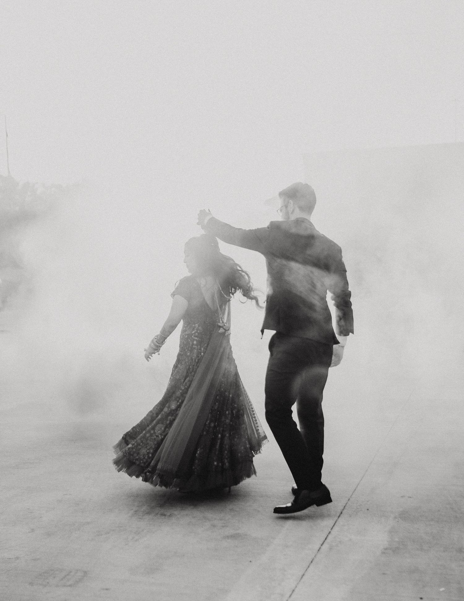 Ethereal black and white photos capture a dancing couple in foggy atmosphere.