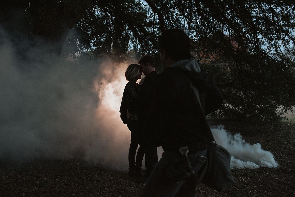 Silhouettes of photographers working during dramatic sunset through trees. 
Jojo Pangilinan Photographers, Dallas based Destination wedding