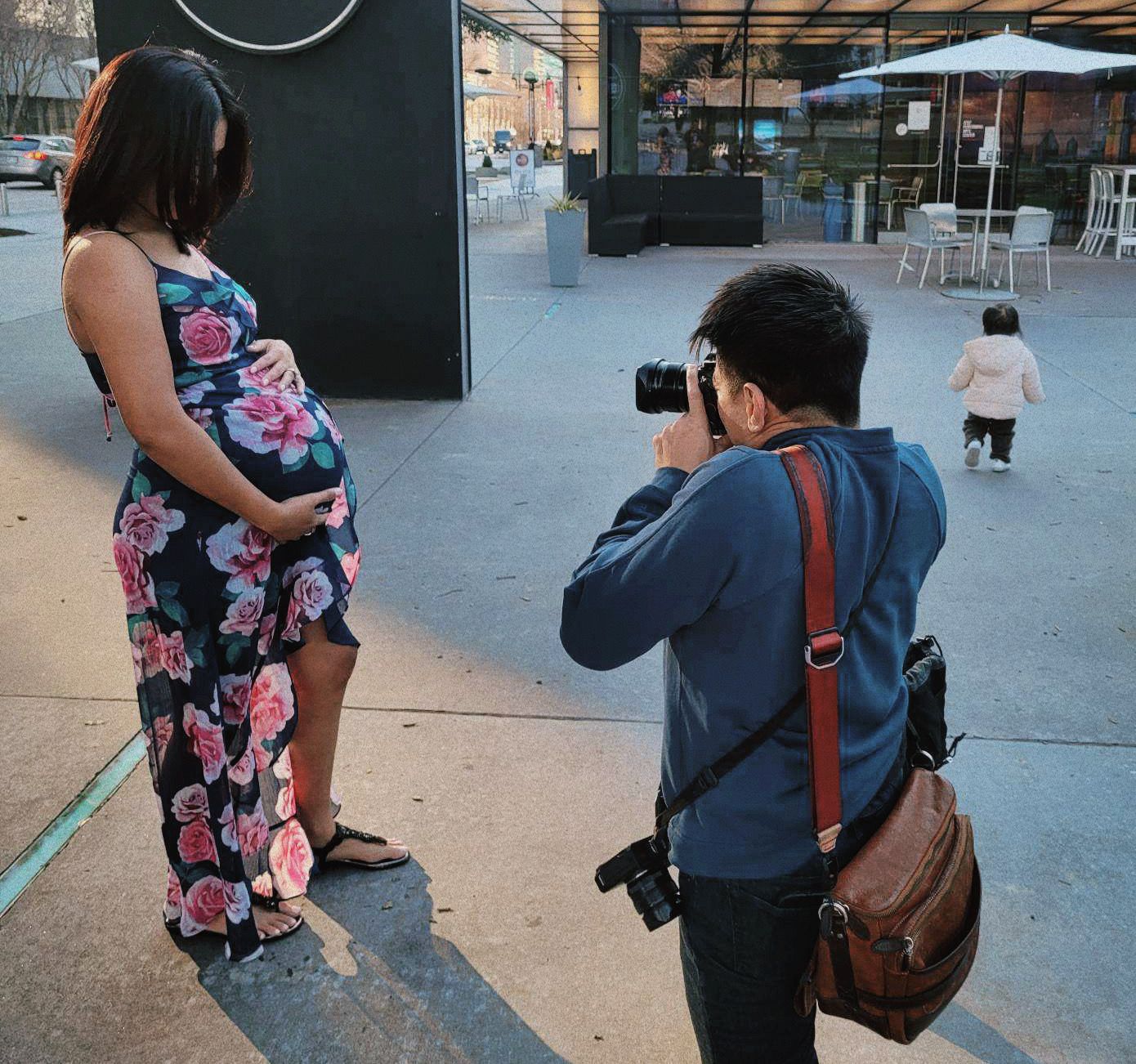 Photographers with camera gear walking through urban setting. Jojo Pangilinan Photographers, Dallas based Destination wedding photographer
