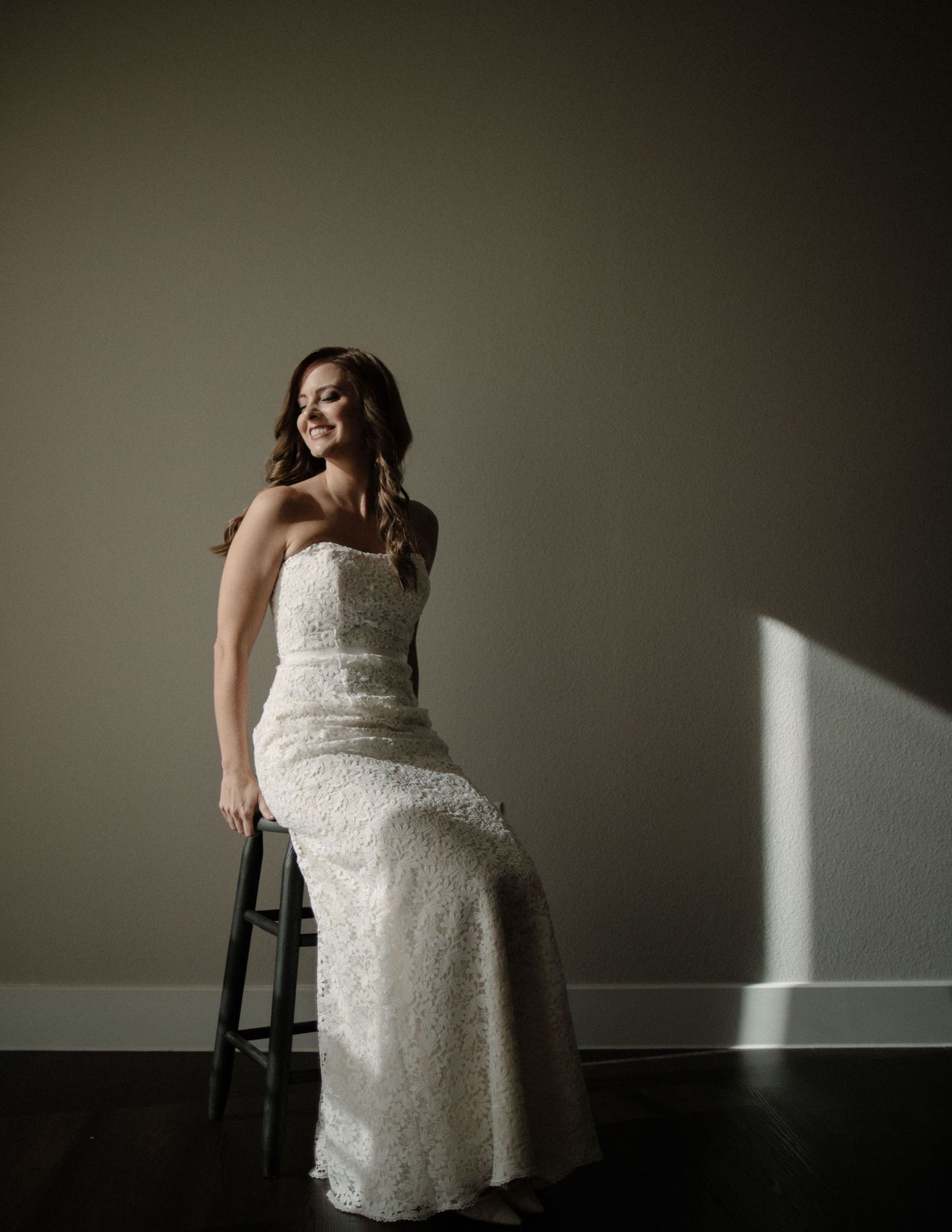 Artistic bridal portraits in white lace dress against a minimalist dark background.