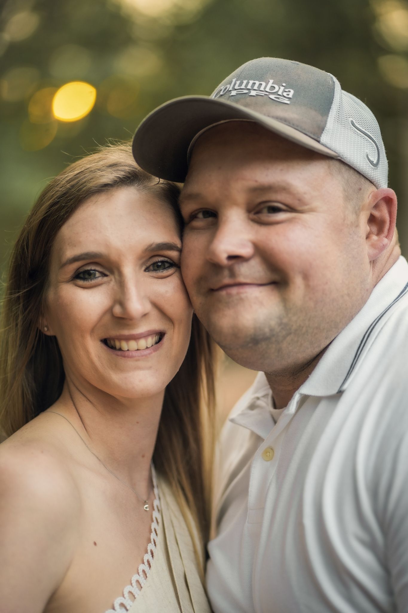 A couple shares intimate moments during an outdoor photo session at golden hour.