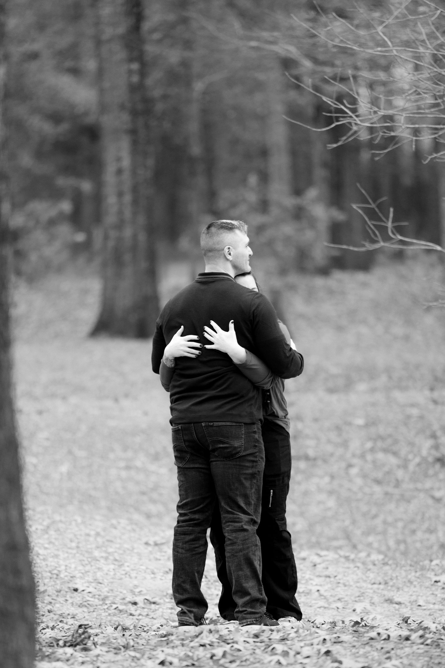 A black and white photo sequence showing two people hugging in a wooded outdoor setting.